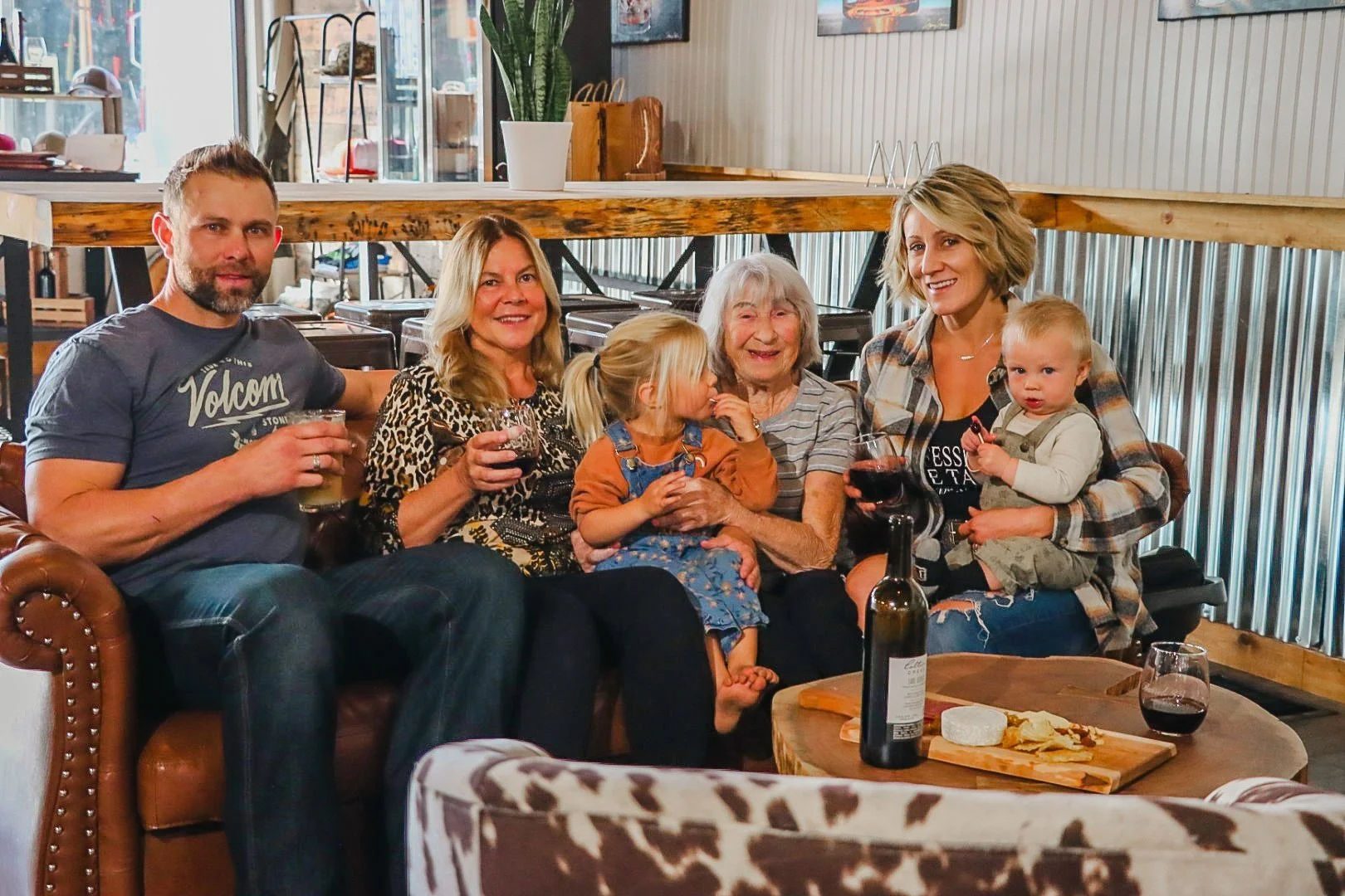 A group of happy people on a couch inside Barrel 33