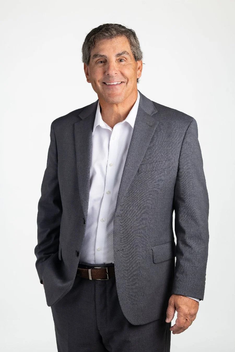 A middle-aged man, Bruce Nemovitz, in a gray business suit and white shirt smiling against a plain white background.