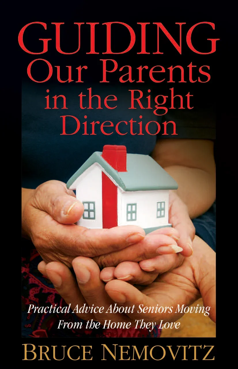 Book cover titled 'Guiding Our Parents in the Right Direction' with a photograph of two senior hands holding a small model house, and a subtitle 'Practical Advice About Seniors Moving From the Home They Love' by Bruce Nemovitz.