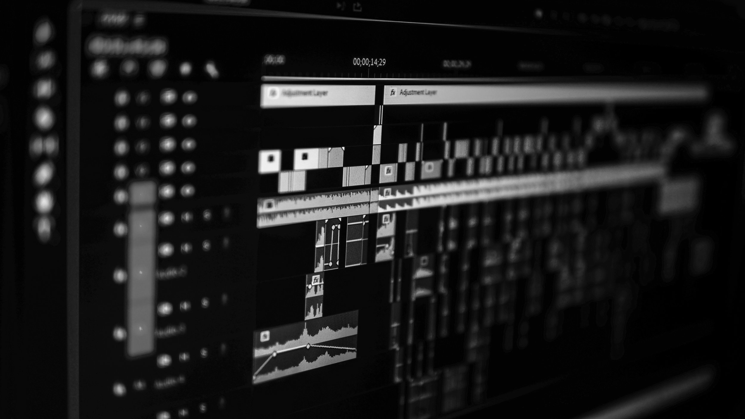 Black and white screenshot of a computer video editing software interface with multiple video and audio tracks, clips, and editing tools.