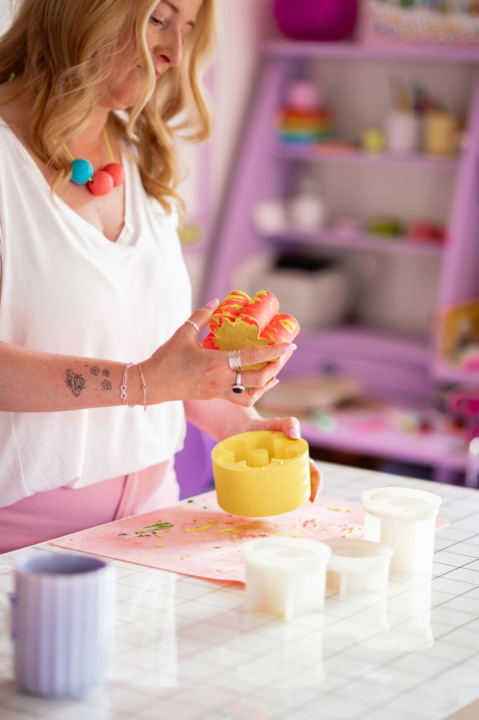 Melissa is unmoulding a jesmonite piece in her studio