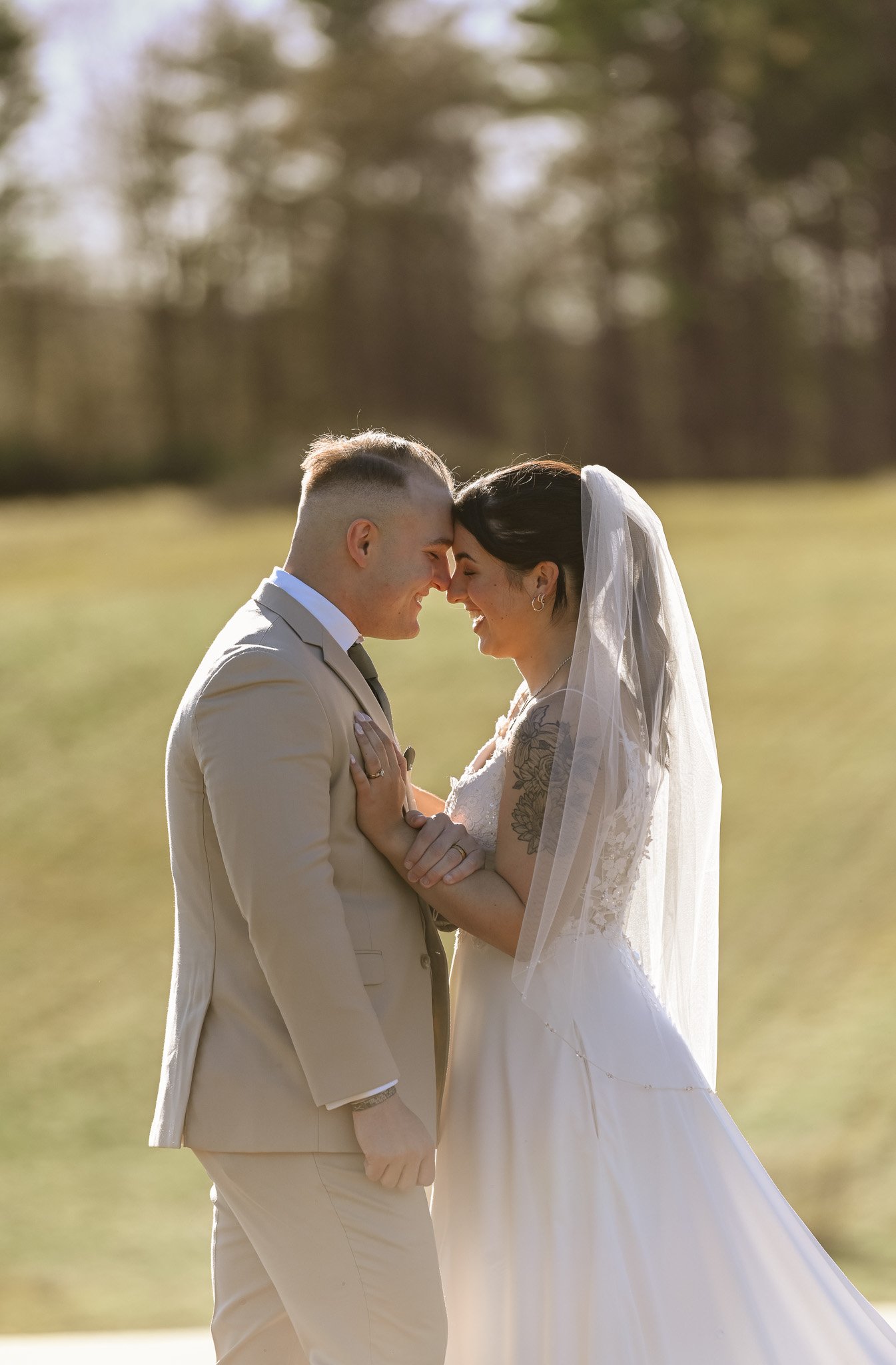 A groom holding a small book or notepad during a wedding ceremony, with the bride standing in front of him.