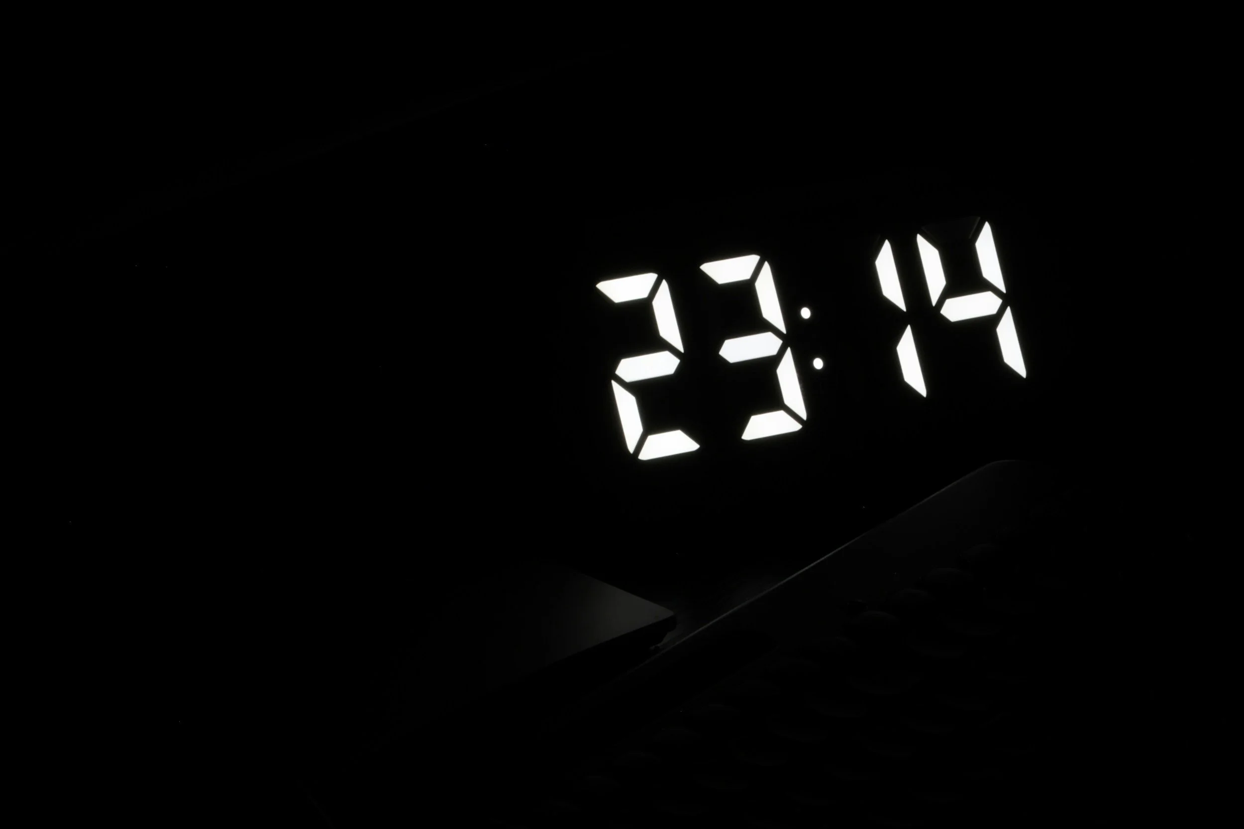 A bedside clock showing a late-night hour, for waking in the night