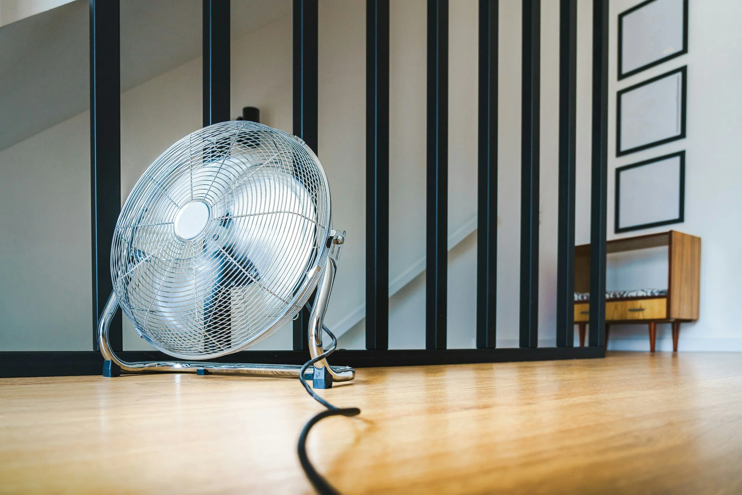A standing fan cooling a room, for hot flashes and night sweats