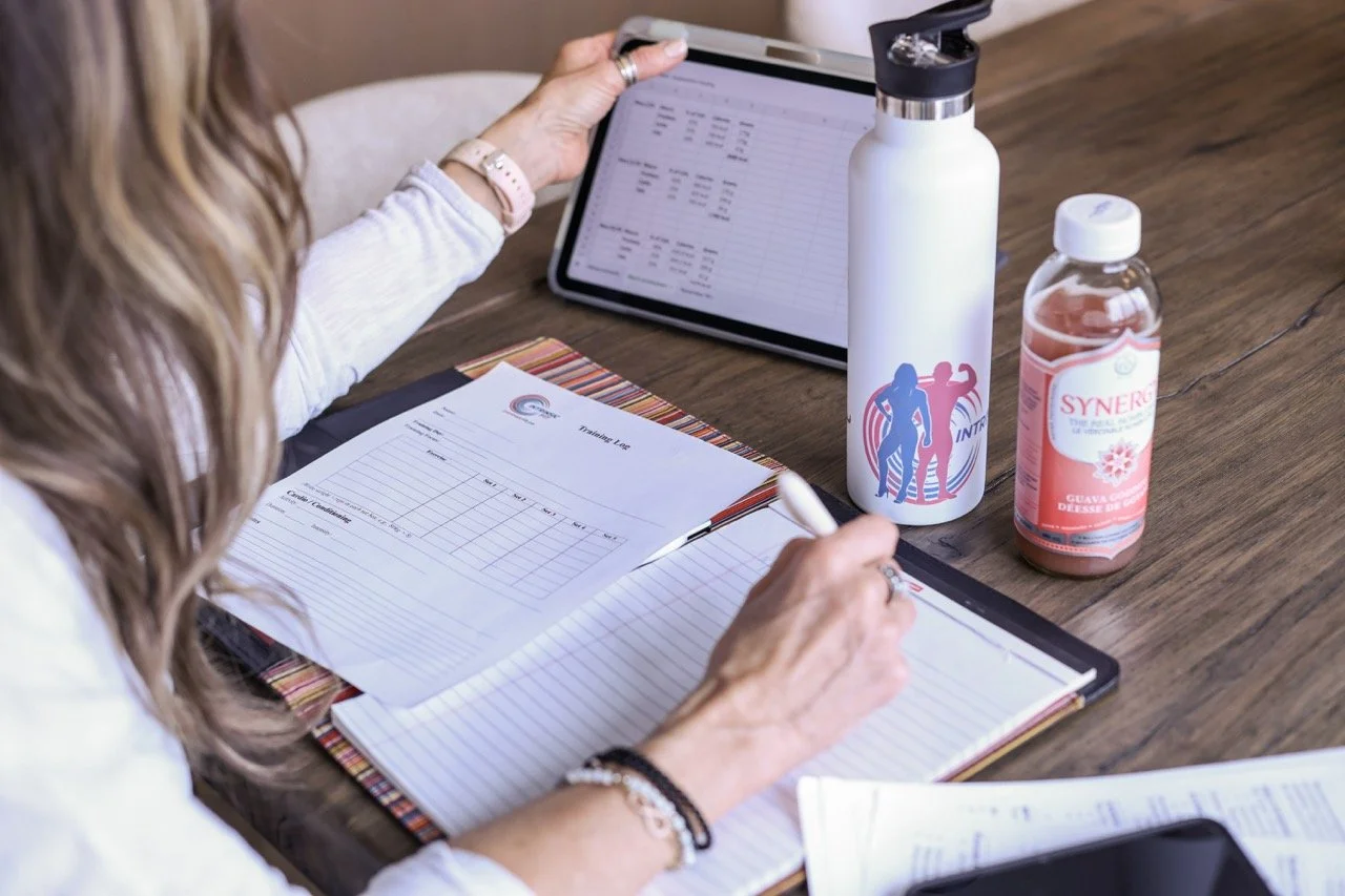 photo of woman sitting at table going through her client plans