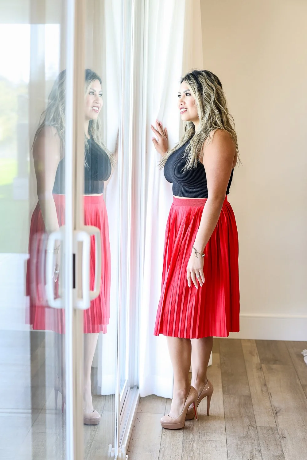 calgary woman in business looking out window in beautiful skirt