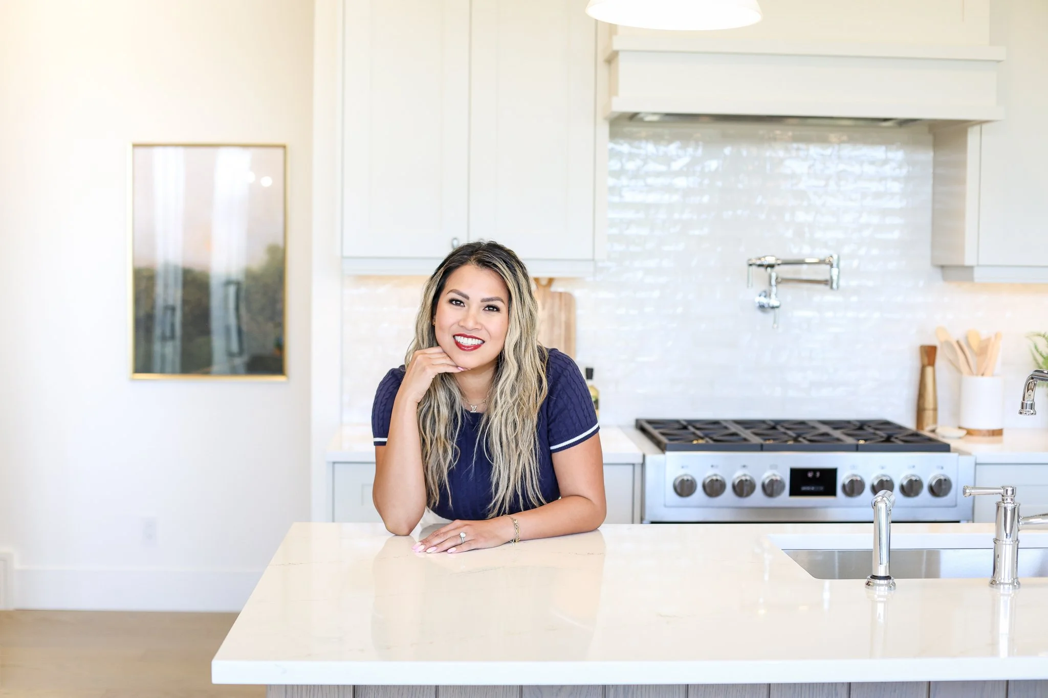 calgary realtor leaning on a counter in a beautiful showhome