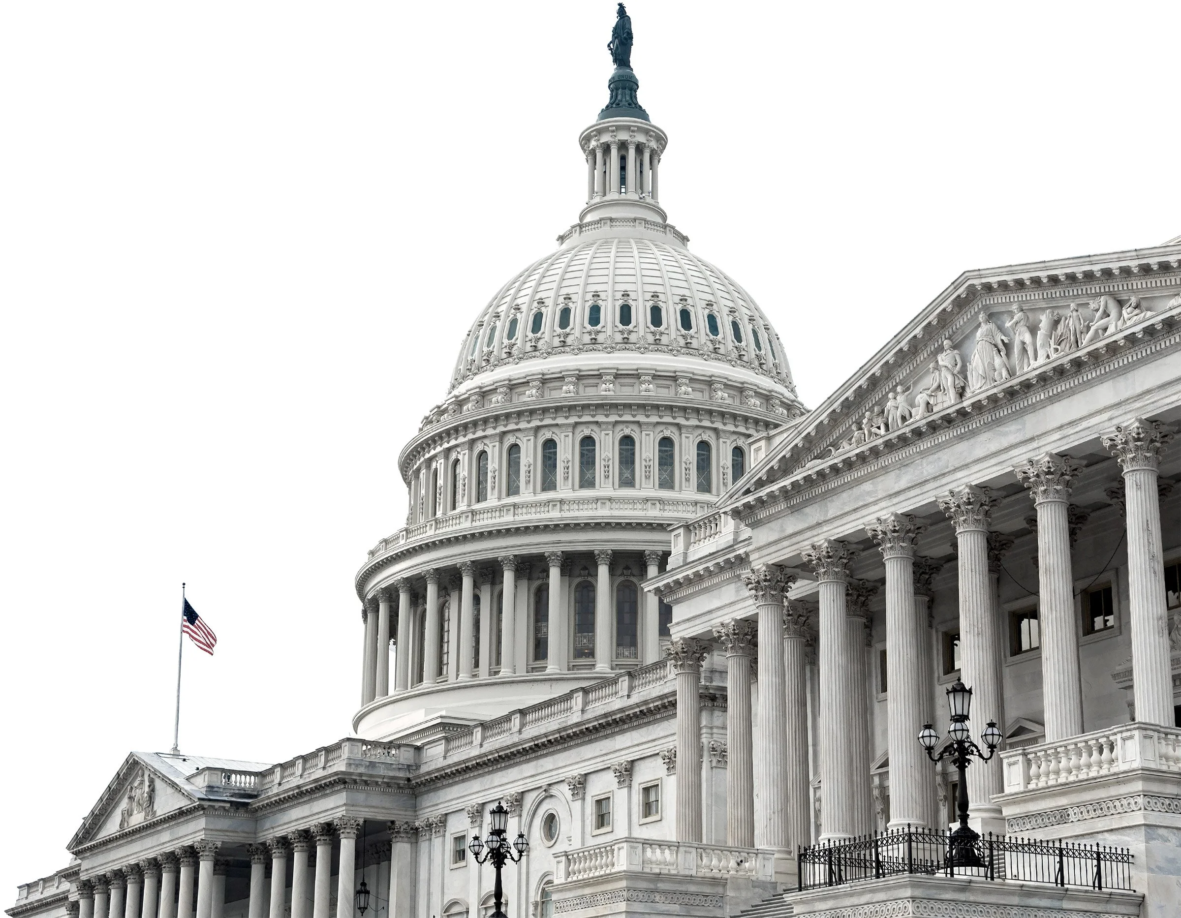 United States Capitol building with dome and columns, American flag flying nearby, overcast sky.