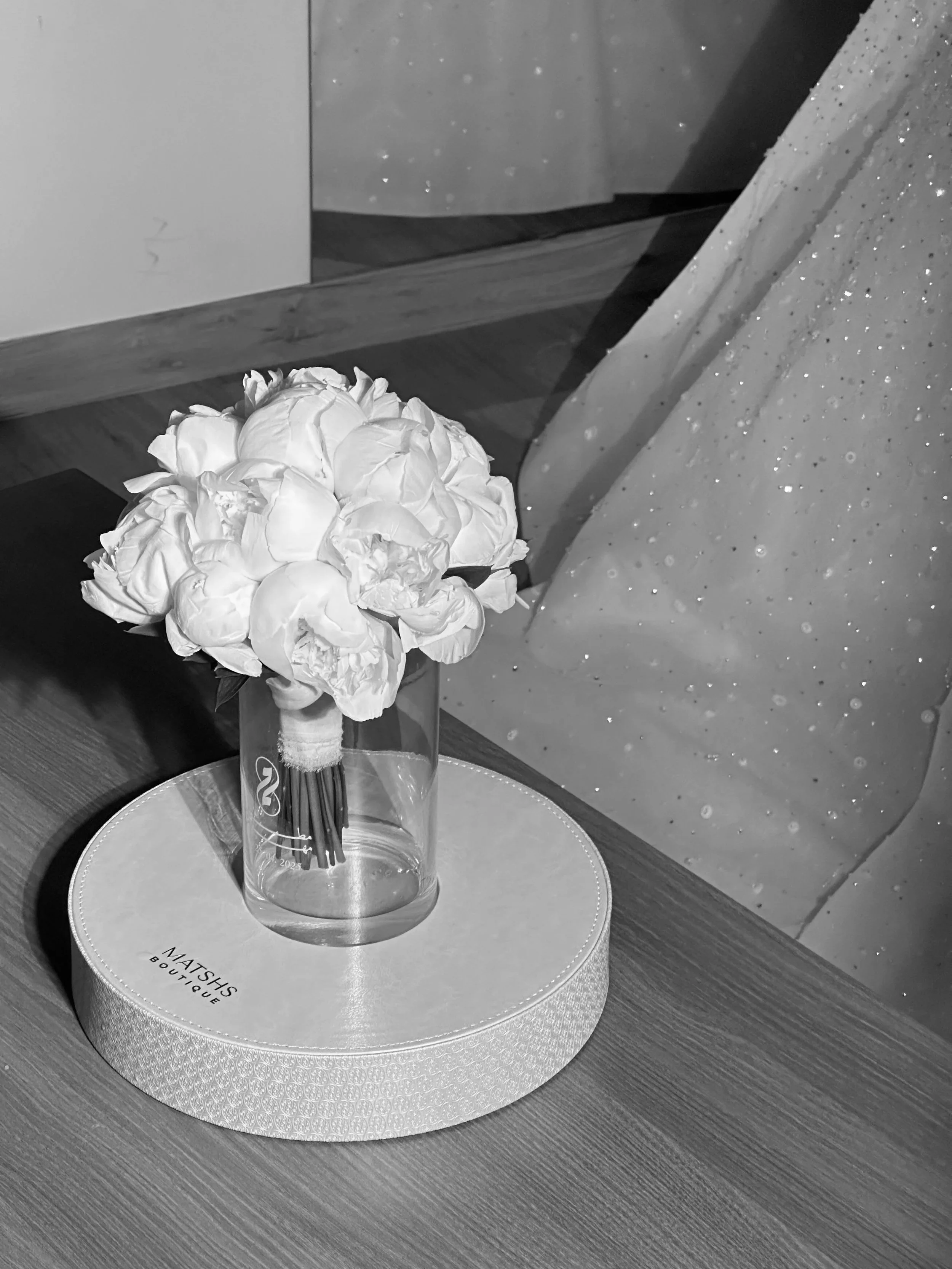 A bouquet of white flowers in a glass vase, wedding content creator dubai, wedding content UAE, wedding photography and videography, best wedding content creator dubai, wedding content creation expat