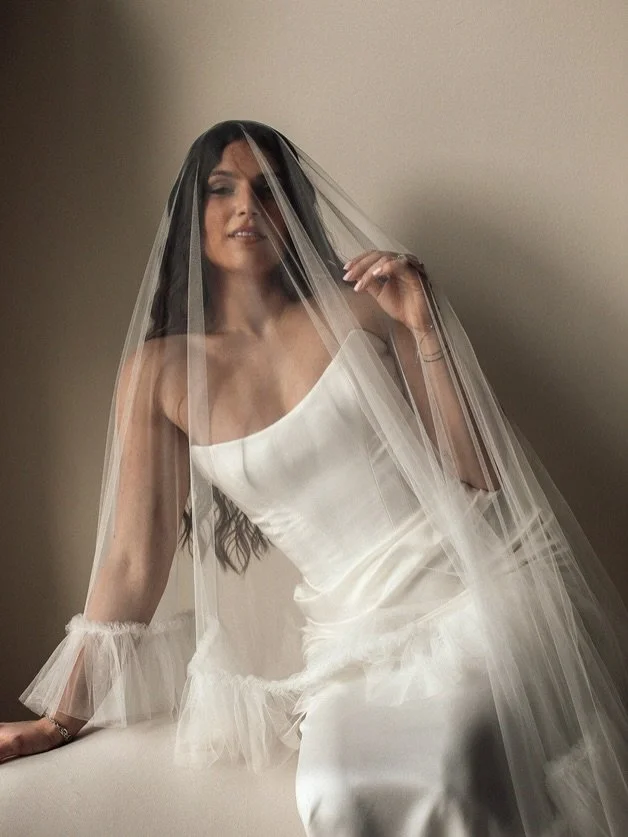 Moments of our Christiane gown captured beautifully by our girlfriend @savannahgrimm 

Designed for the bride who demands both refinement and versatility, this silk masterpiece features a perfected cat-eye neckline and a baby basque waistline. The tr