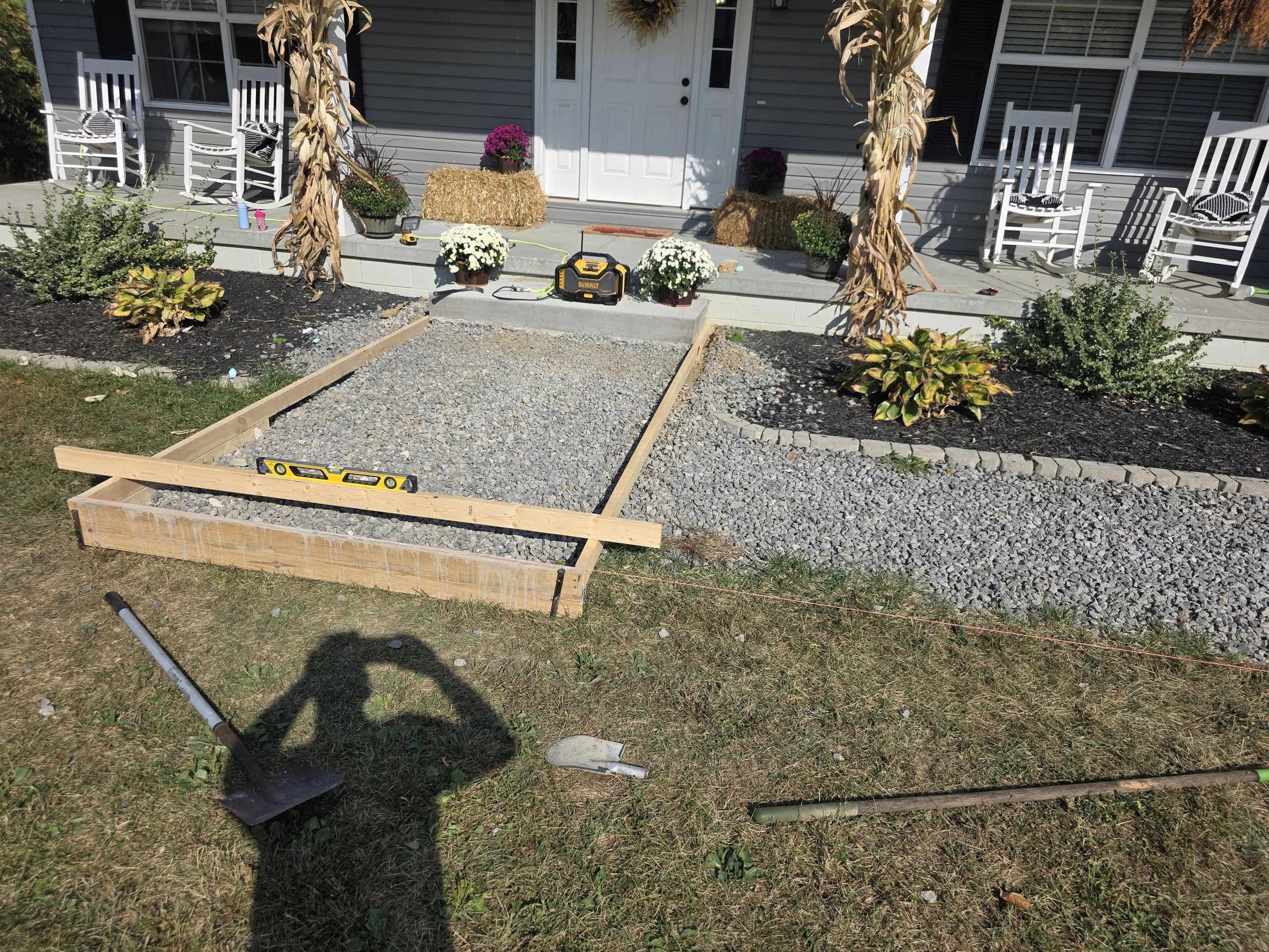Gravel walk with wooden form, level, mulch.