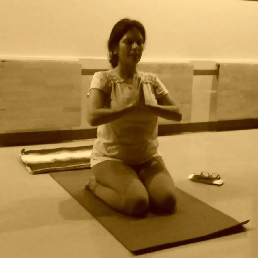 Anu seated in Virasana in yoga class