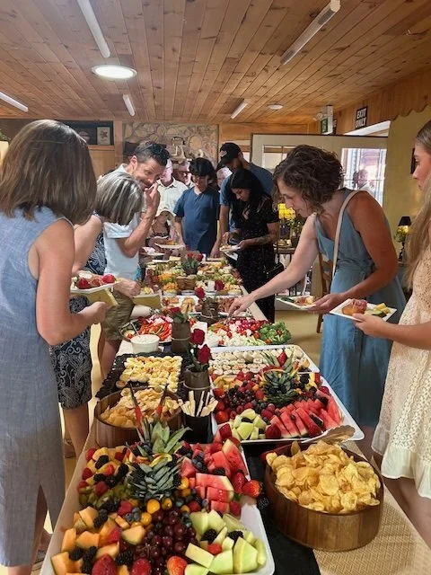 People enjoying a buffet of food at Wattle & Daub event space