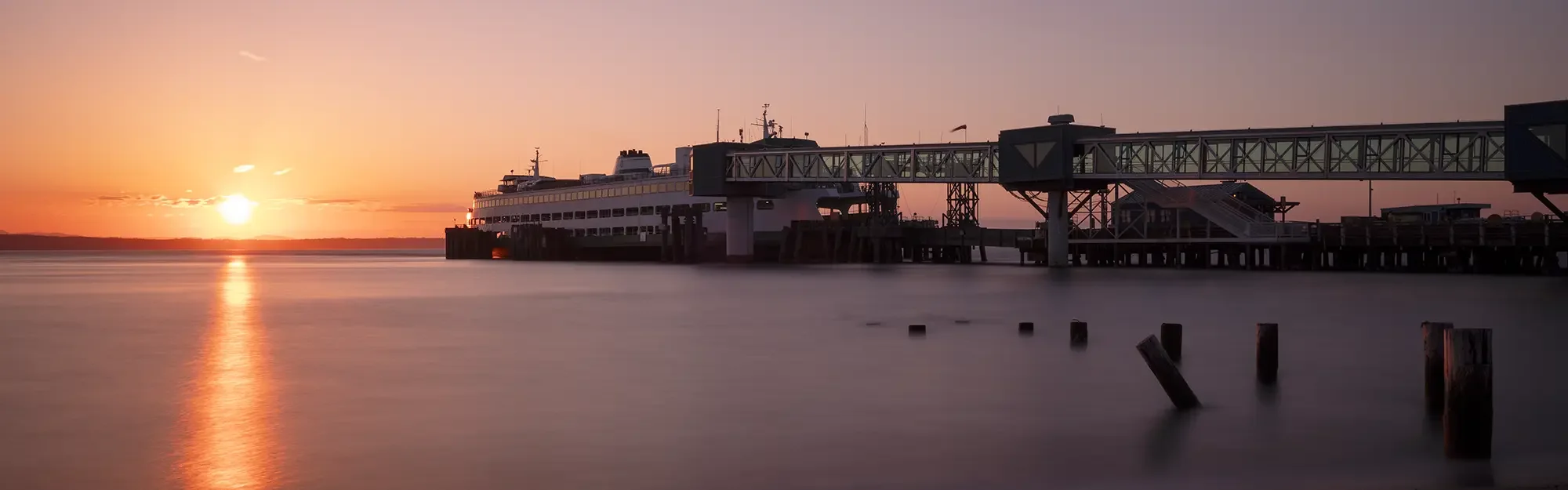 ferry docked at the terminal in Edmonds, WA as the sun sets