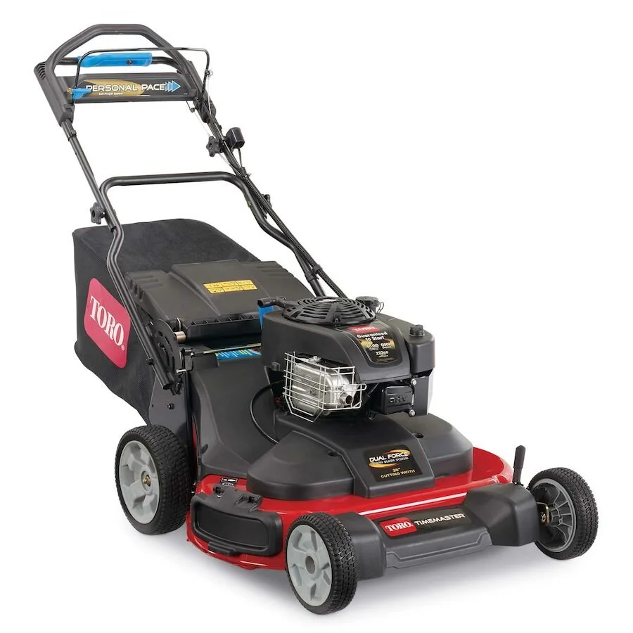 A Toro TimeMaster commercial lawn mower with a gas engine, large cutting deck, and wheels, used for mowing lawns.