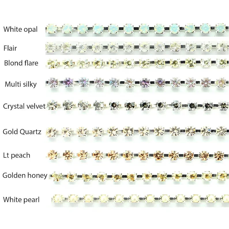 A chart displaying various styles of rhinestones or jewelry stones, arranged in rows with labels including White opal, Flair, Blond flare, Multi silky, Crystal velvet, Gold Quartz, Lt peach, Golden honey, and White pearl.