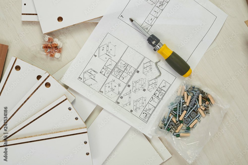 Handyman assembling flat pack furniture with instruction manual, tools, screws, and wood panels. Professional furniture assembly service for IKEA, Wayfair, and other ready-to-assemble furniture in Fort Collins and Northern Colorado.