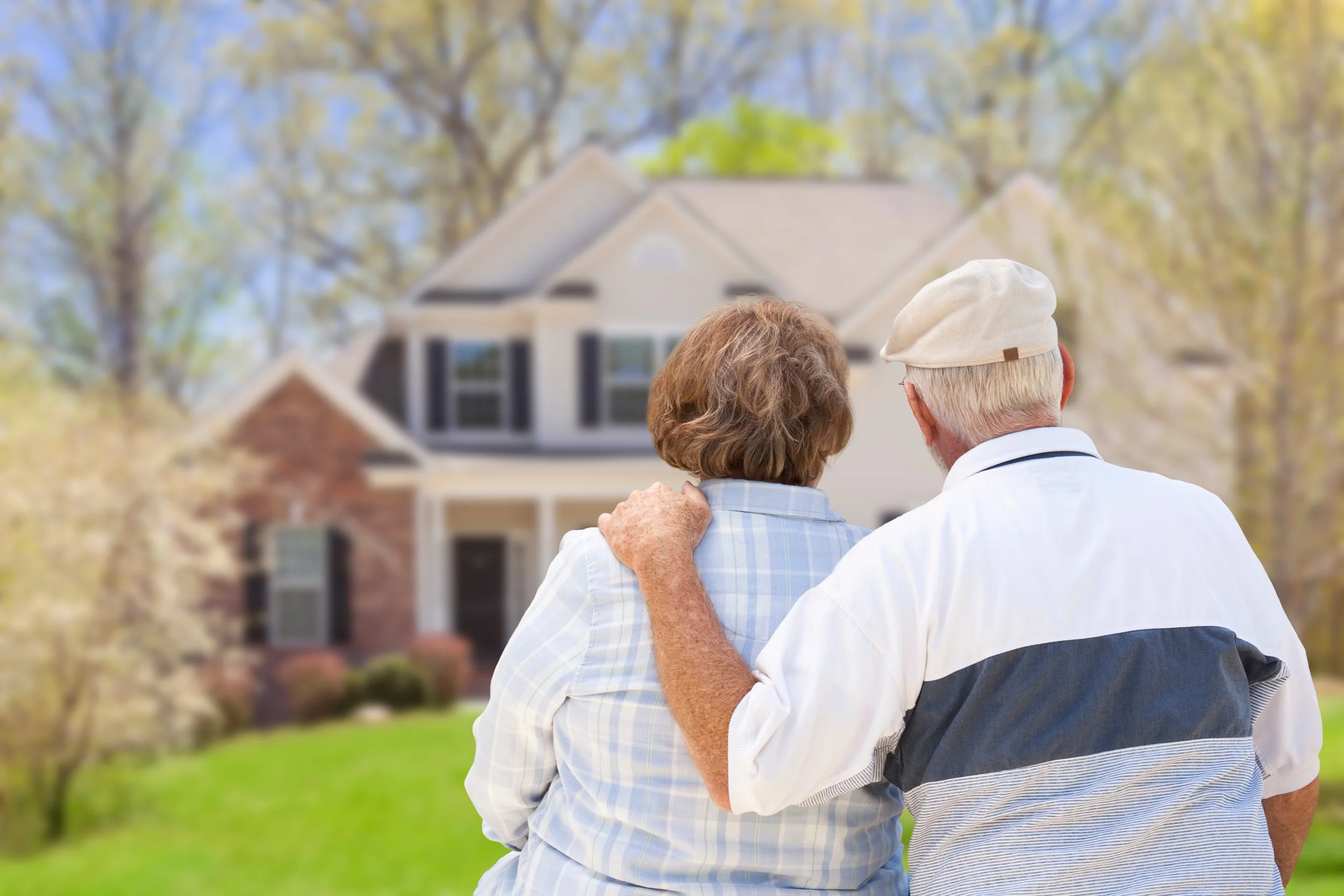 Senior couple looking at their home, symbolizing aging in place with comfort, safety, and independence.