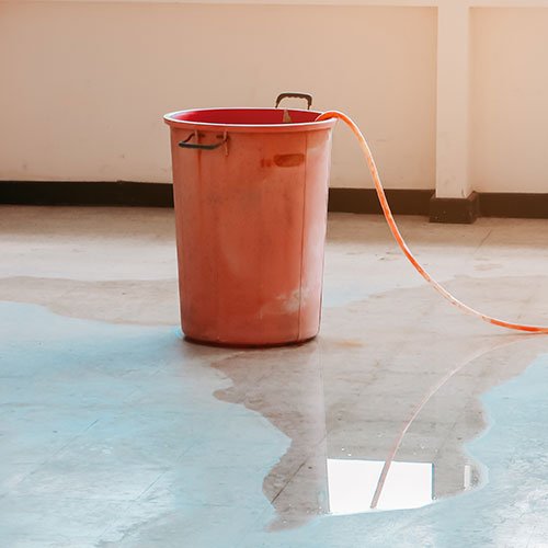 Cleaning up after a backed up drain floods basement.