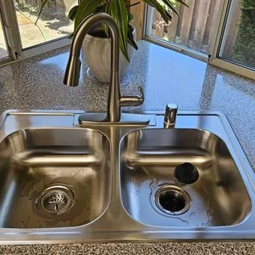 A sink with a garbage disposal installed.