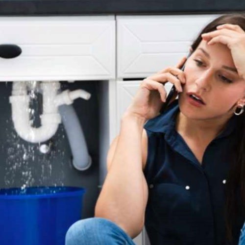 A woman calling to report a leaking pipe.