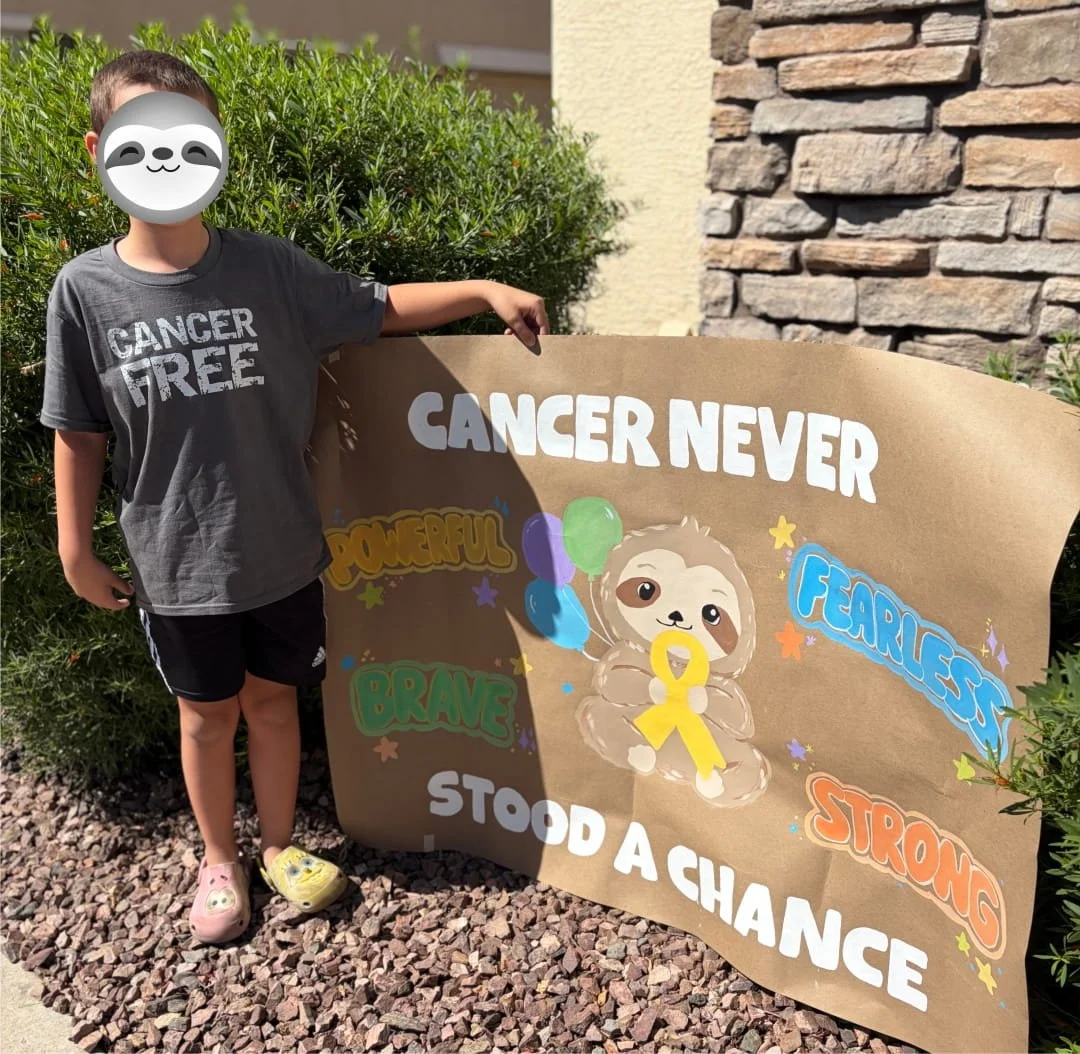 Kid holding a sloth poster