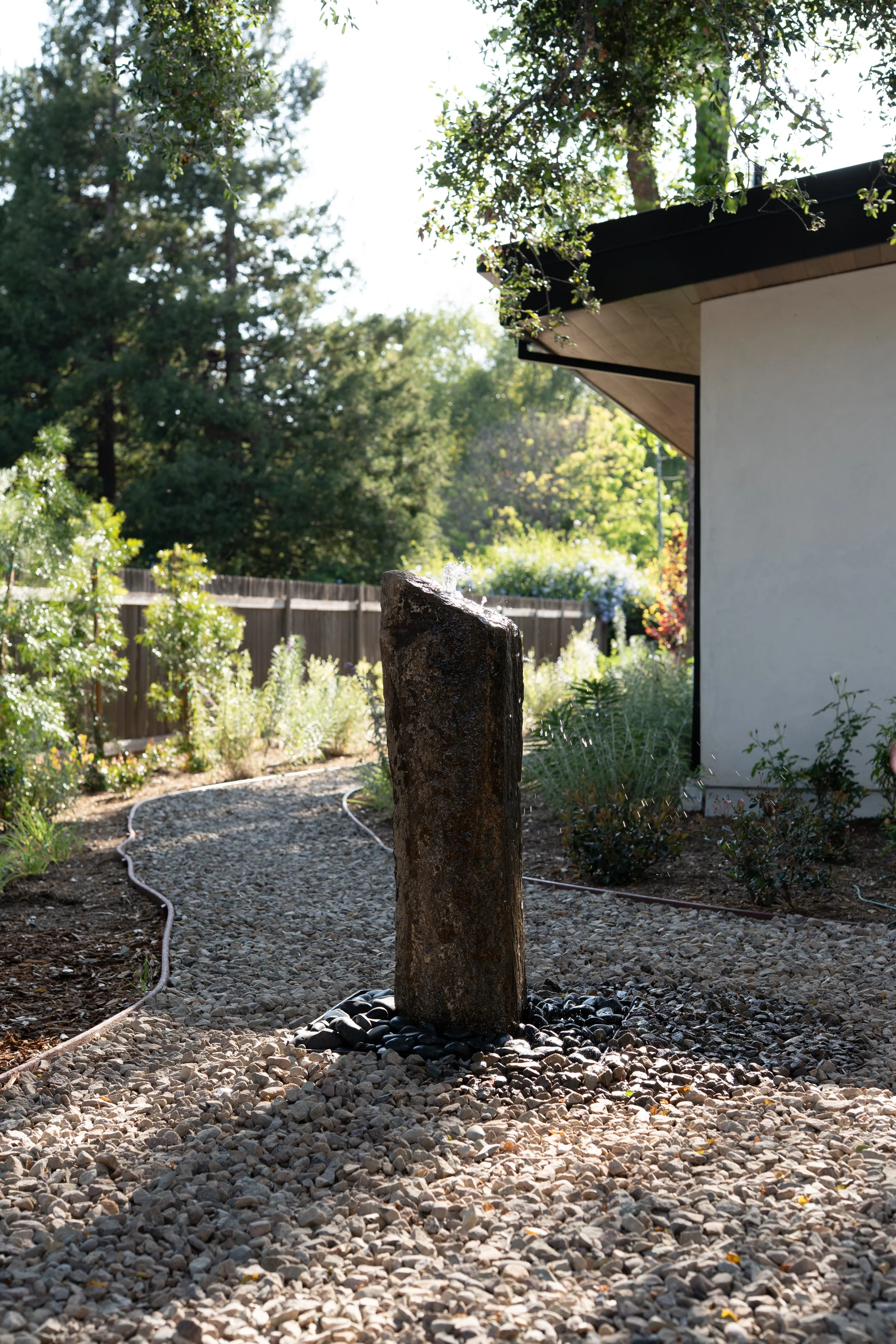 Stone fountain under an oak tree