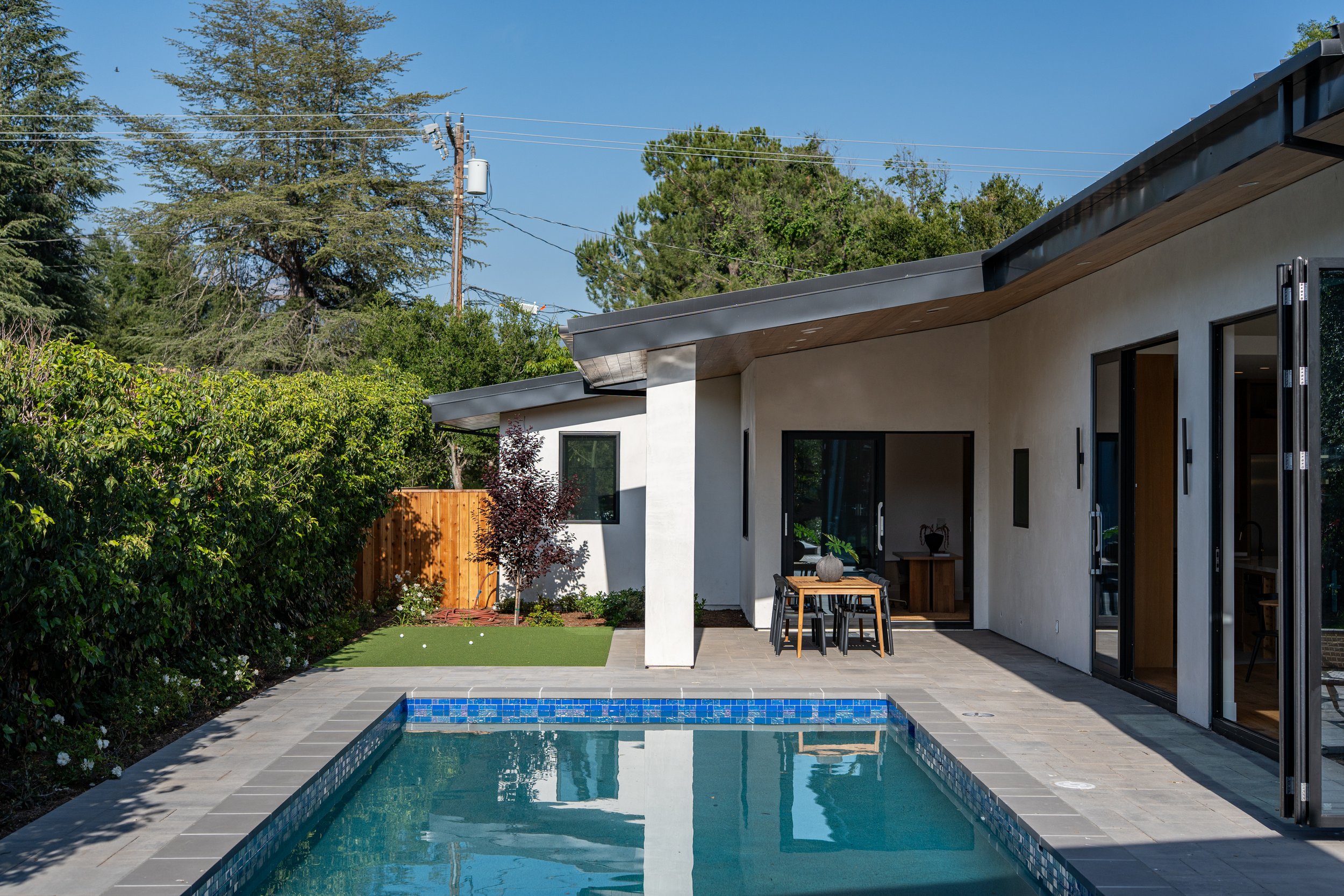 View of swimming pool and covered patio area
