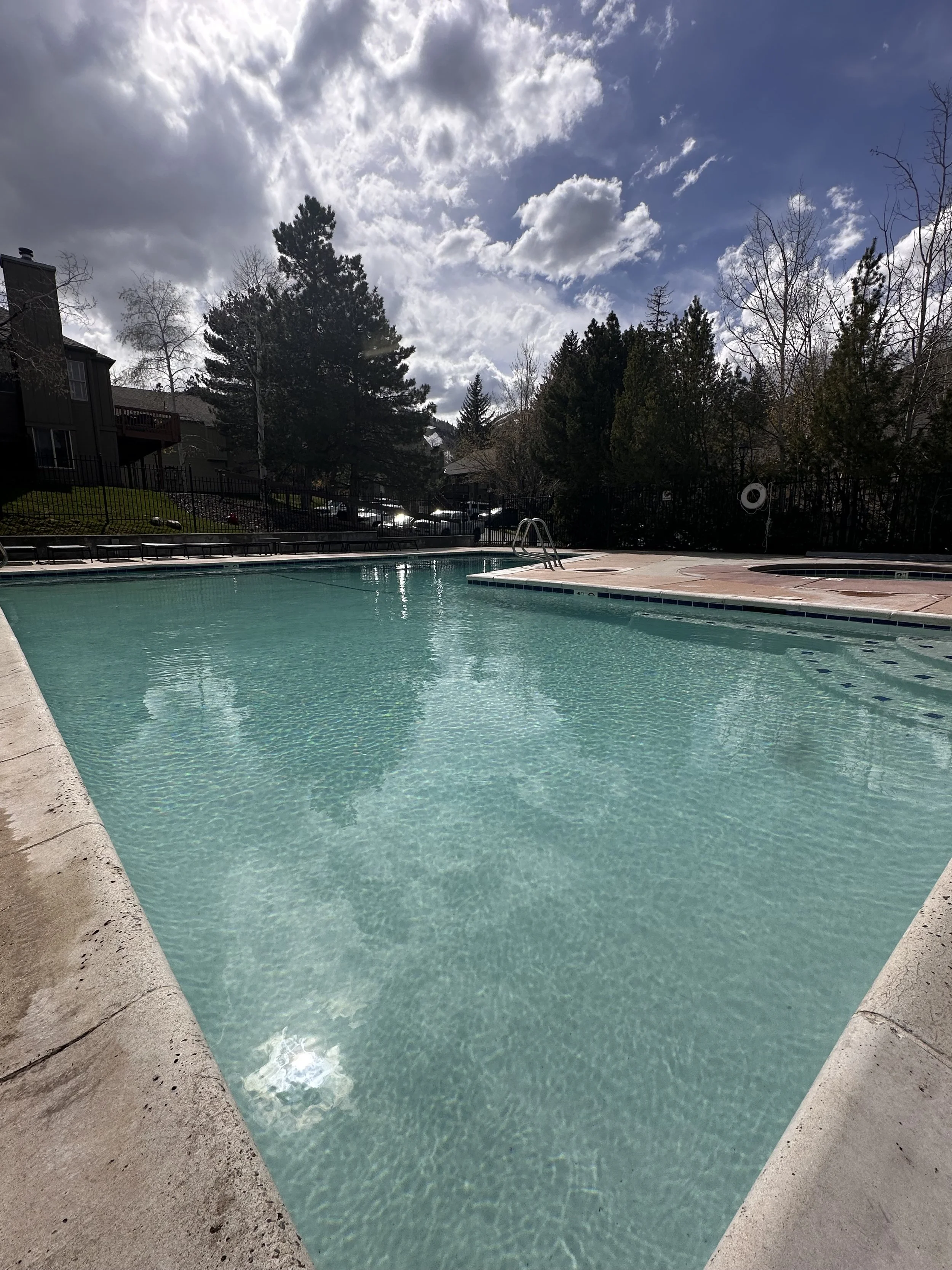 After picture of large pool with shiny white plaster and crystal clear water.
