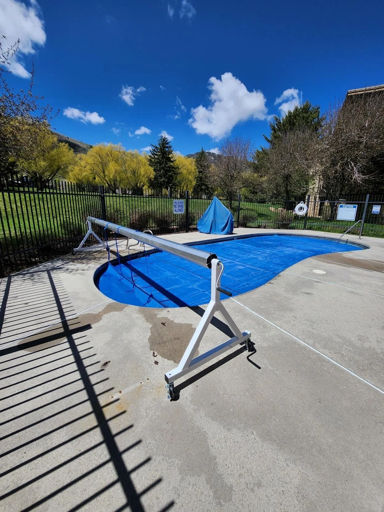 A new cover reel for a swimming pool, with new cover attached.