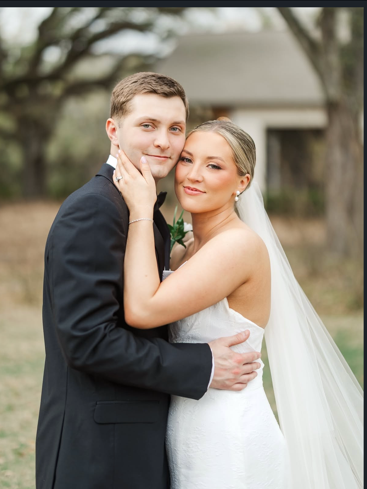 Bride and groom embracing with soft glam bridal beauty and classic hairstyle