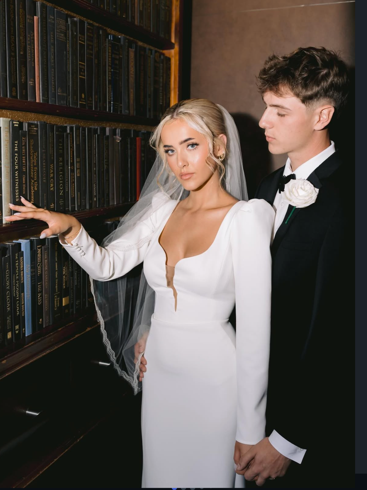 Bride with soft glam makeup leaning on groom during romantic wedding portrait