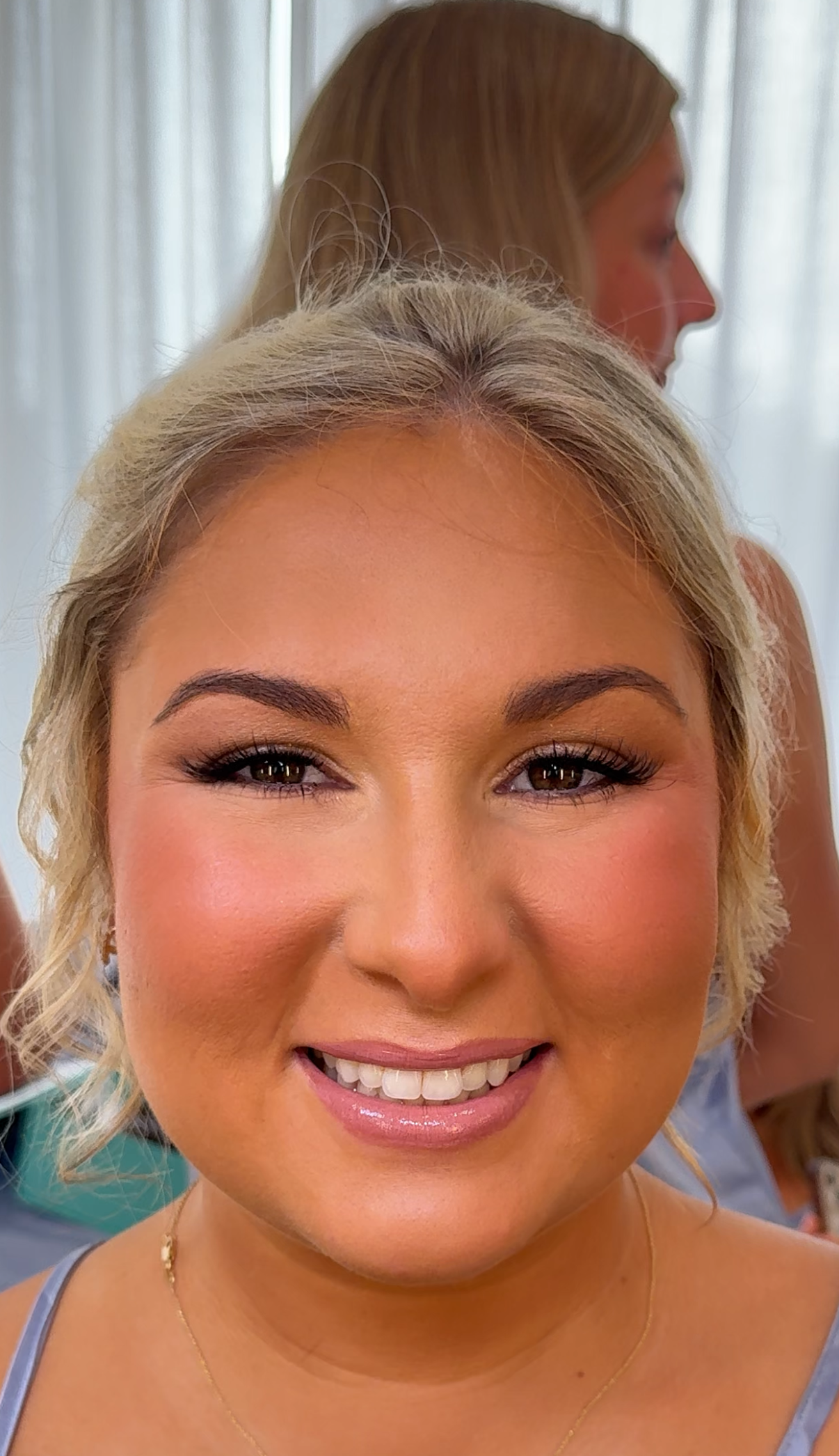 Natural wedding makeup with peach tones and luminous highlight