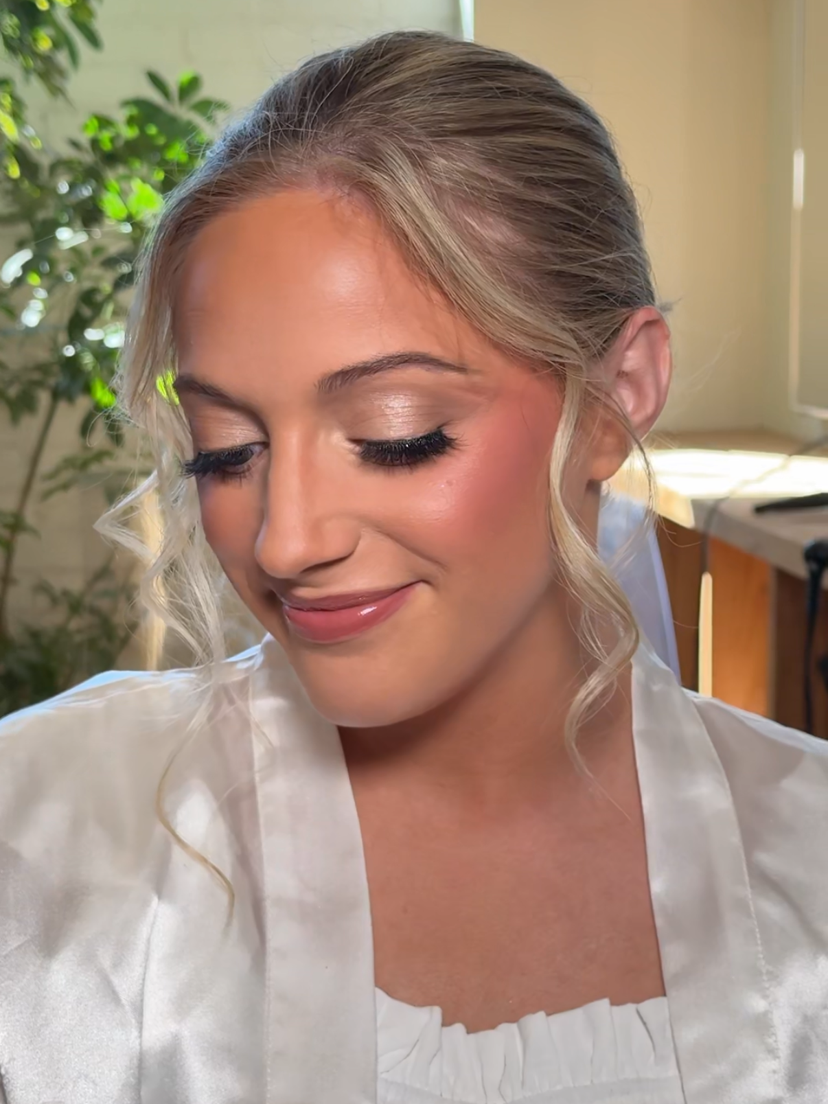 Close-up of soft glam bridal makeup with neutral tones, lashes, and glowing skin