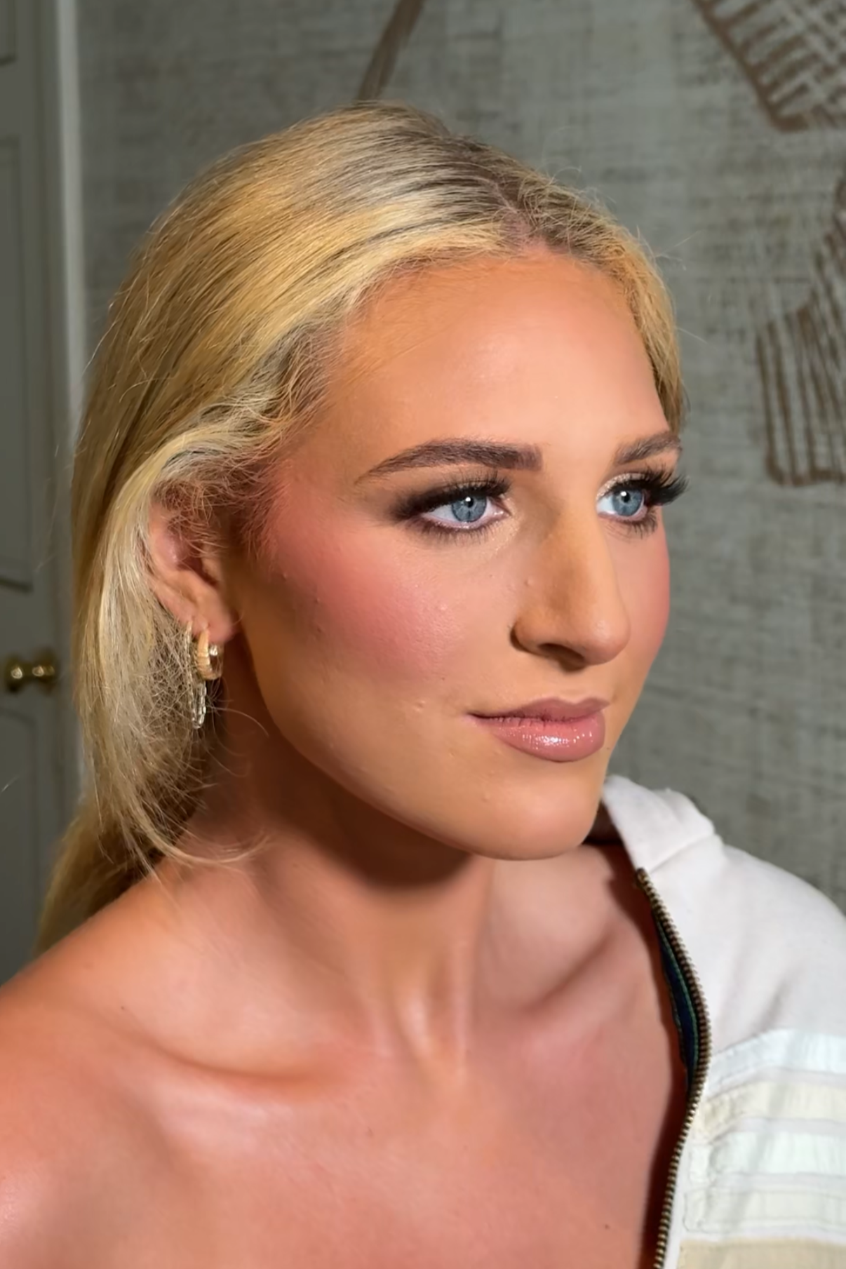 Glamorous wedding makeup look with bronzed skin and soft nude lips