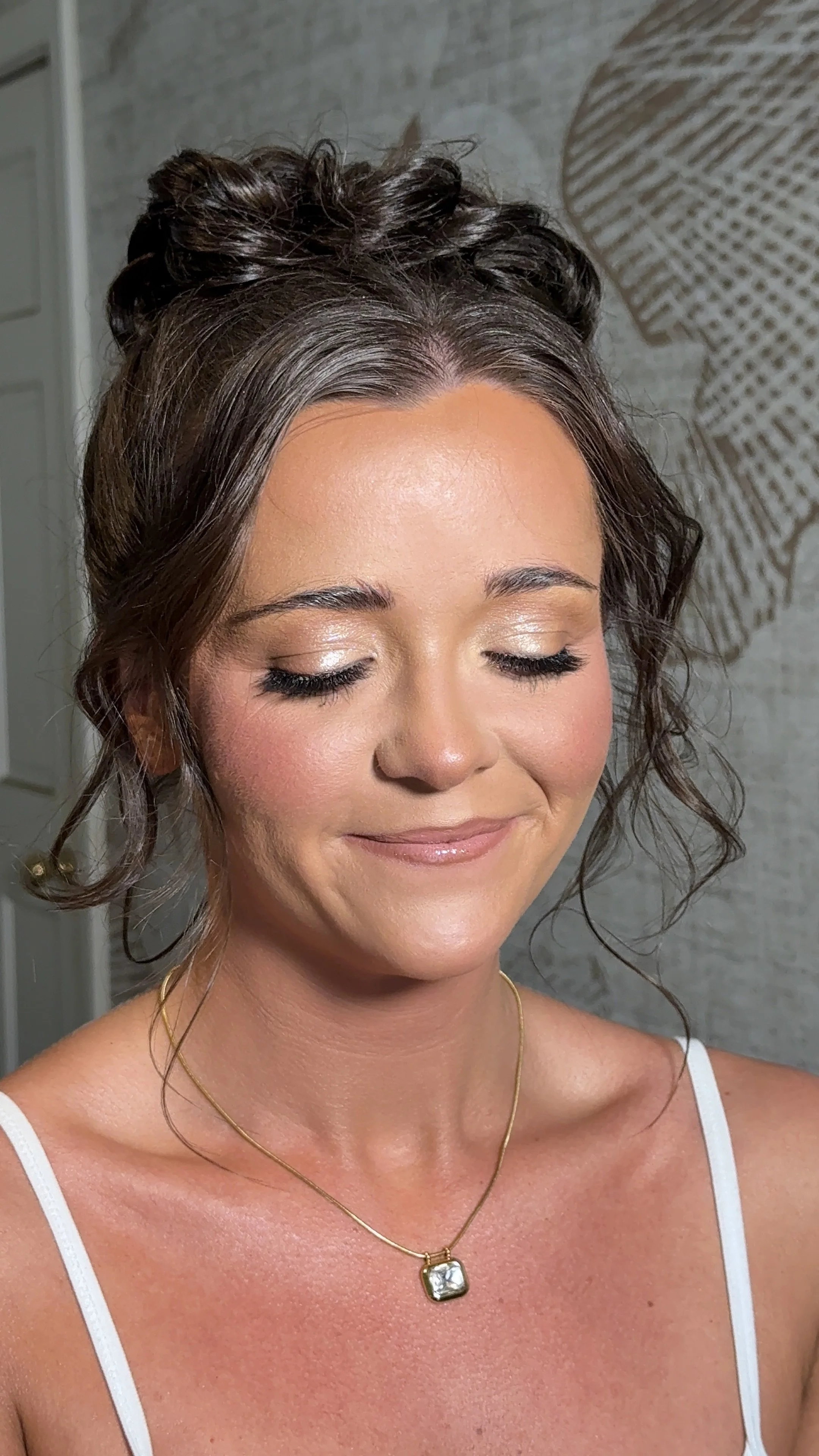 full glam makeup with curly high bun hairstyle by mississippi makeup artist and hairstylist