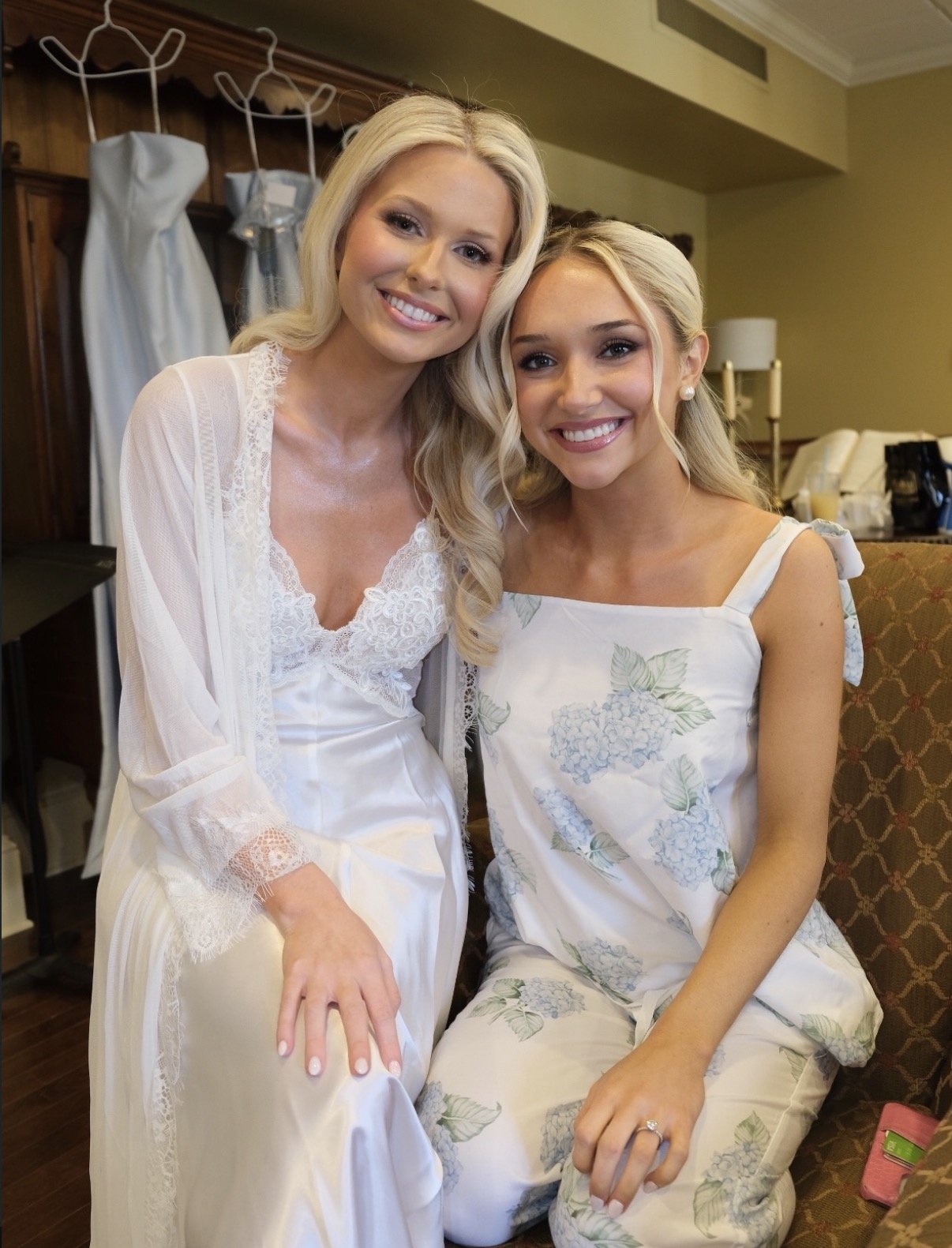 bride posing with bridesmaid with a natural, glowing bridal spray tan