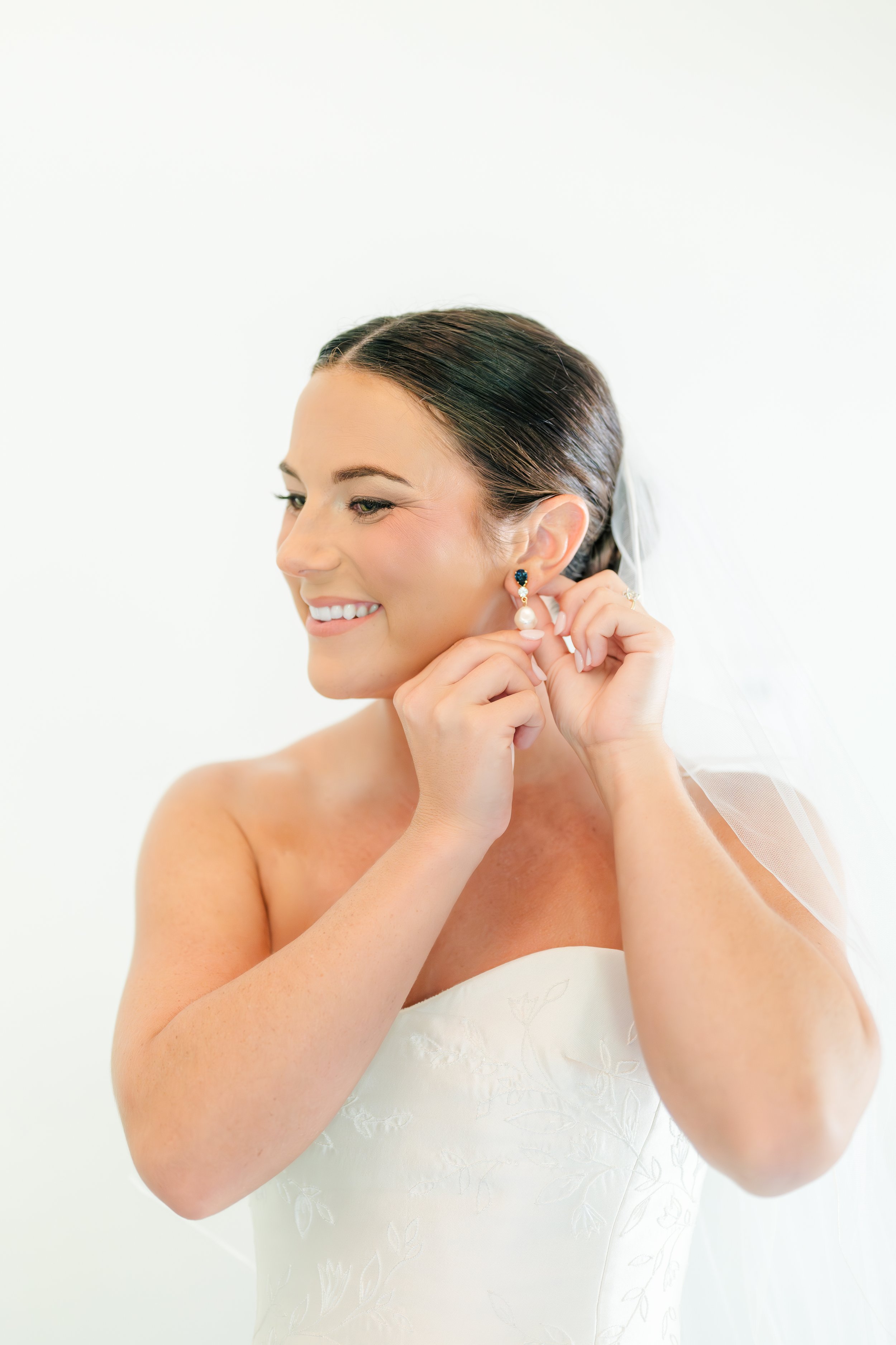 Bride getting finishing touches on wedding makeup before ceremony