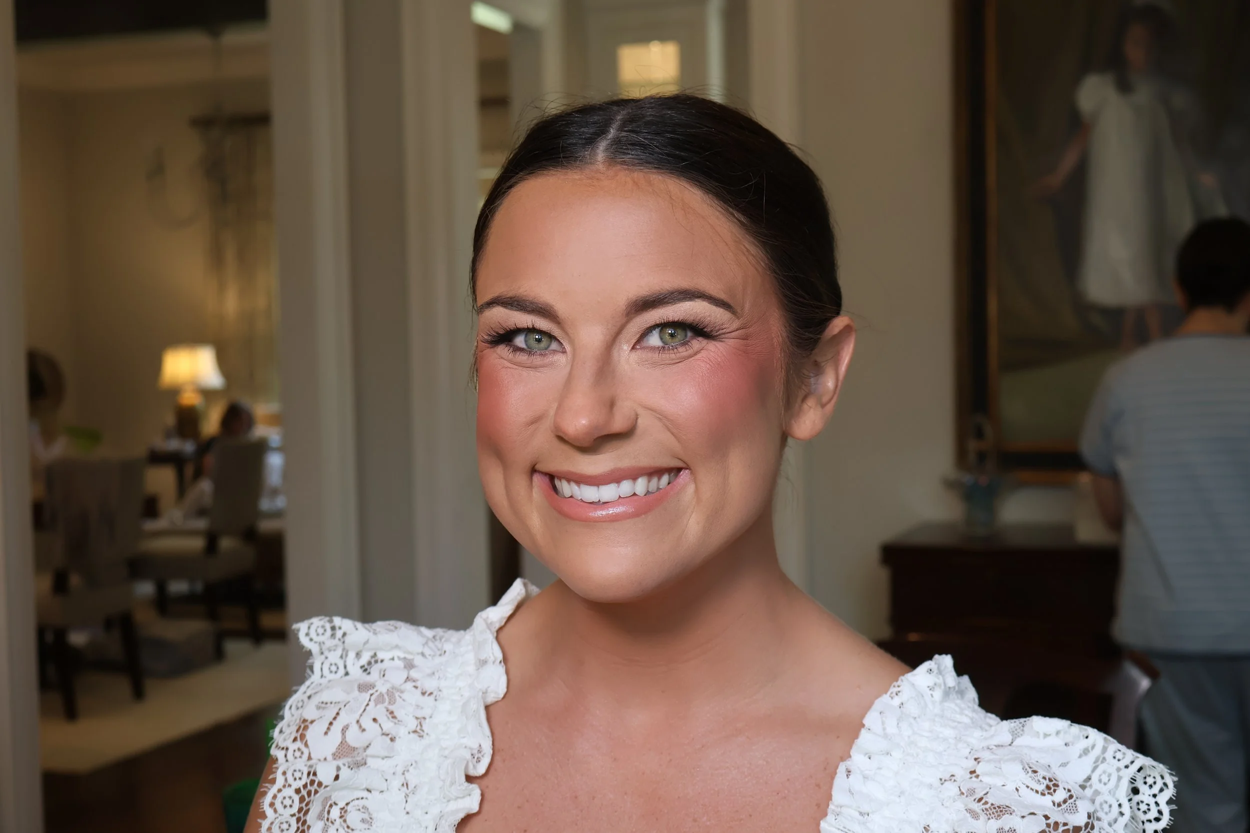 Bridal beauty inspiration featuring sleek low bun and soft wedding makeup