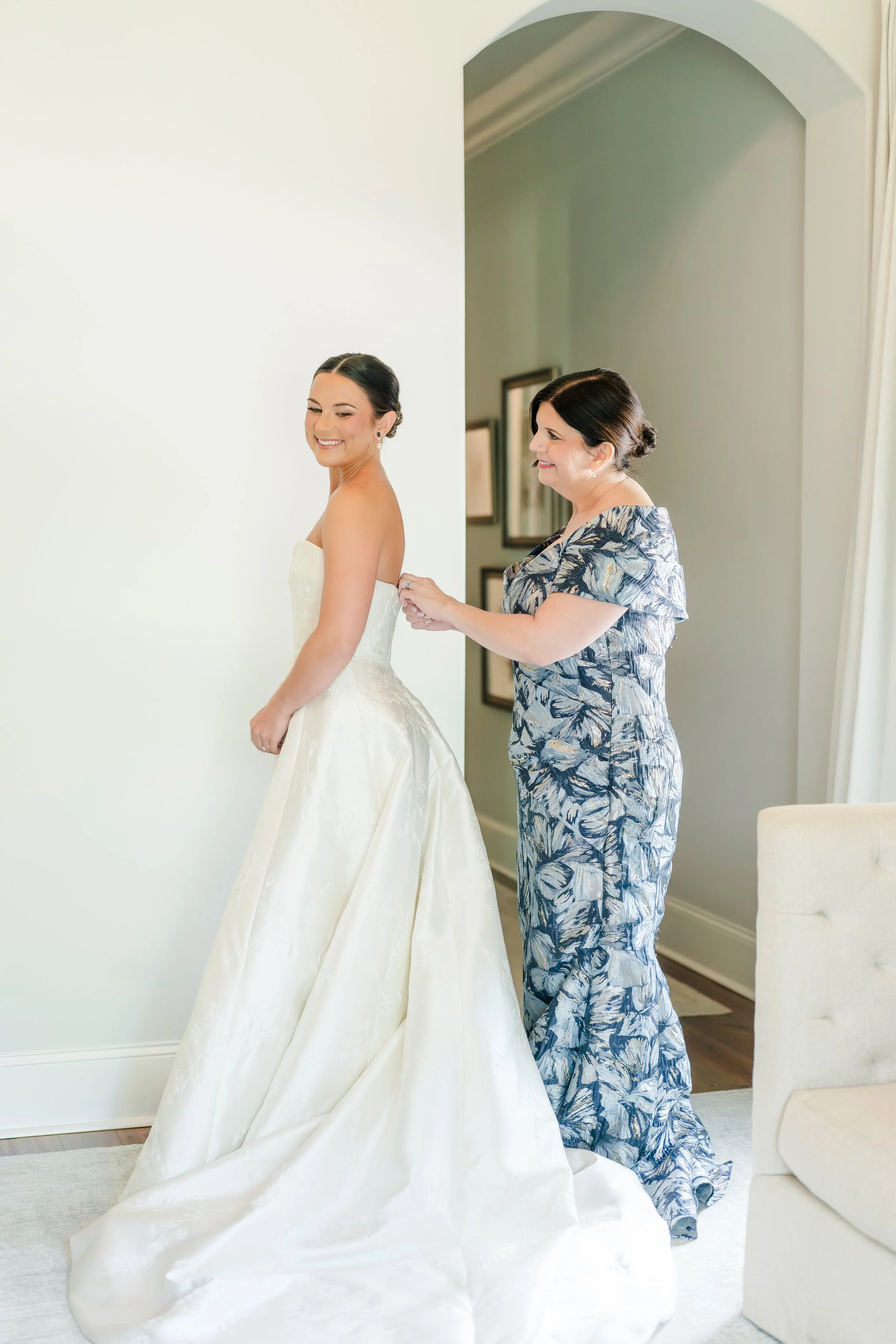 Romantic half-up bridal hairstyle with soft curls and natural glam makeup