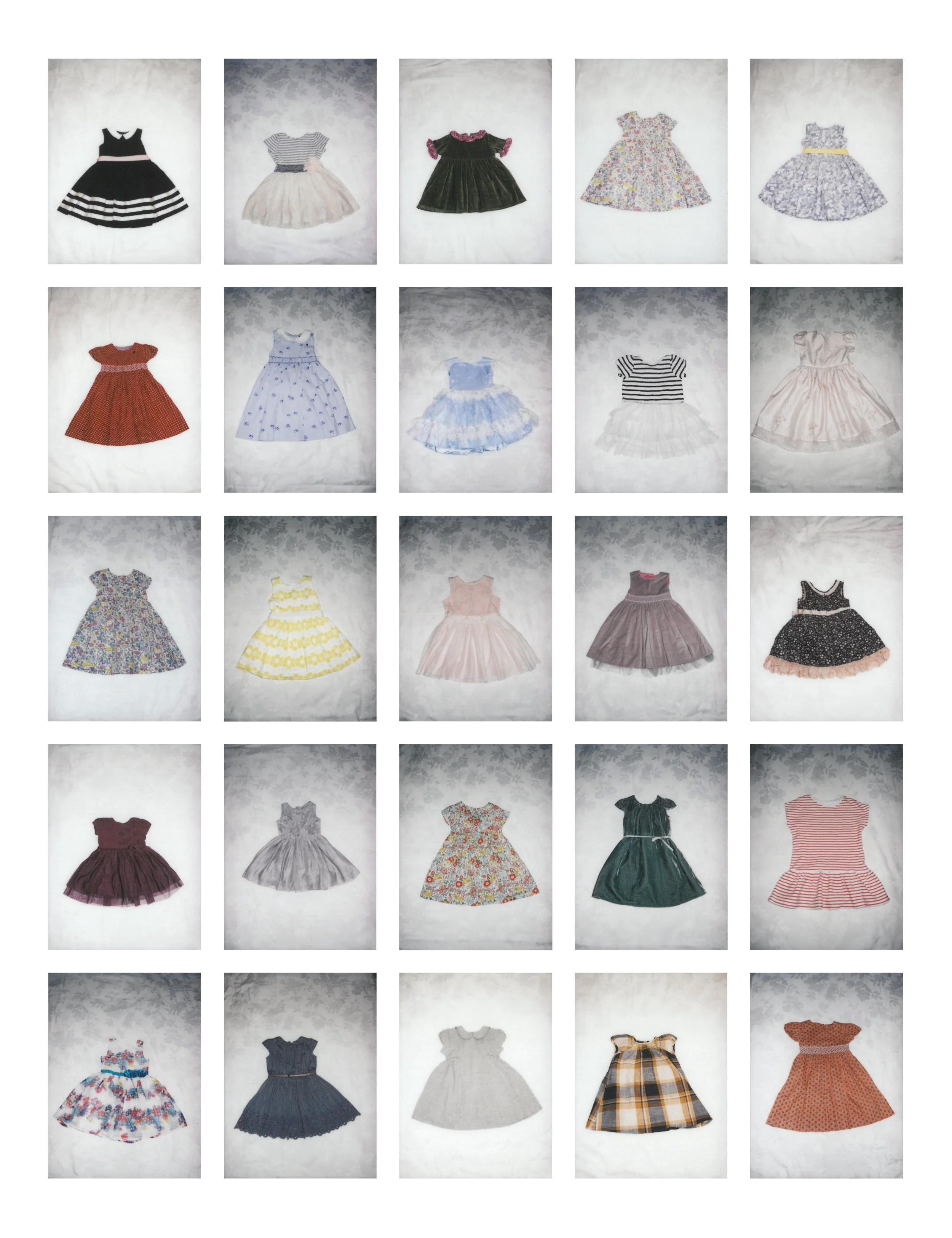 A grid of 25 small, rectangular photographs arranged in five rows of five on a white wall. Each photo is a different children's dress.