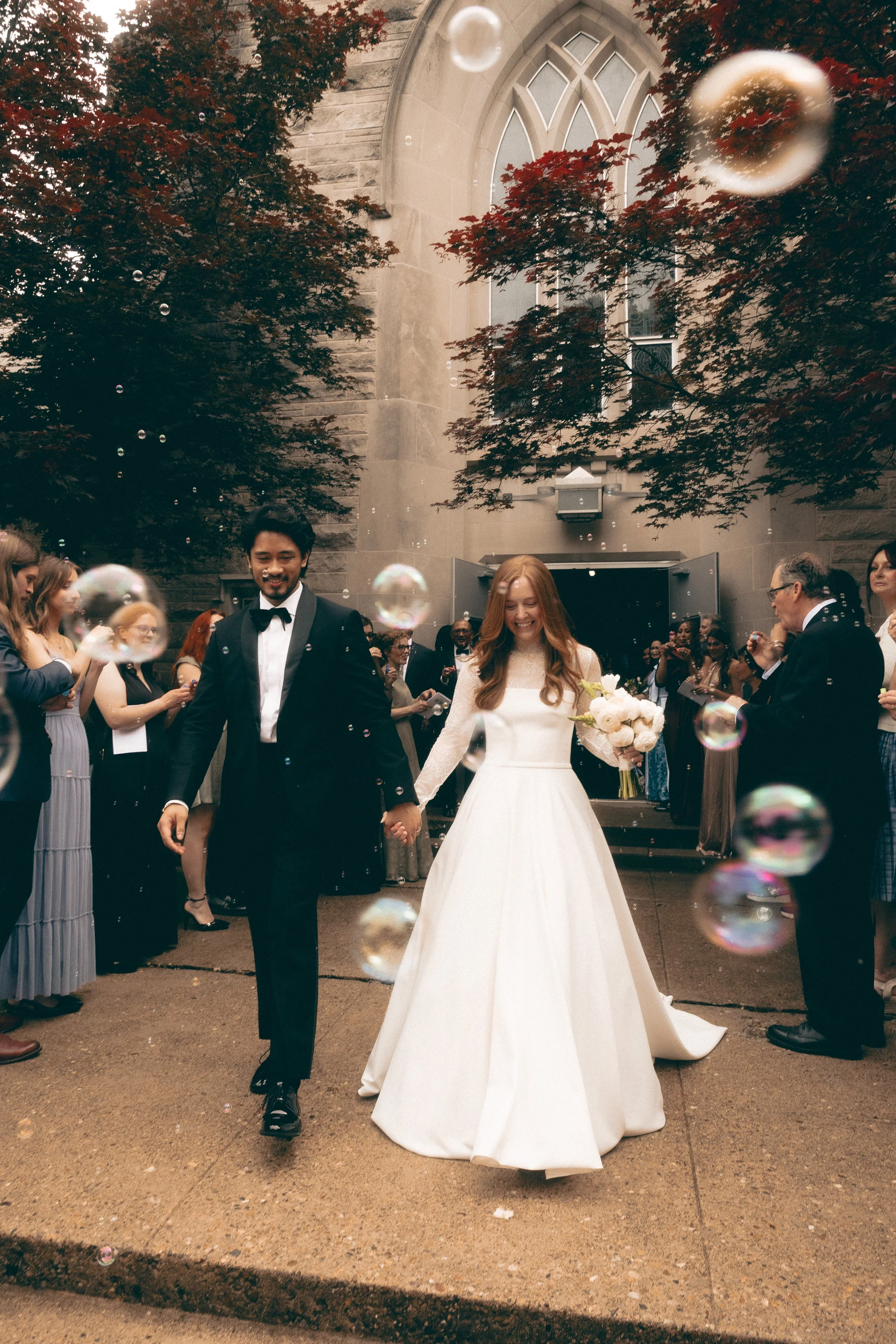 Documentary wedding photograph of a couple exiting their wedding ceremony with bubbles from a southern California wedding