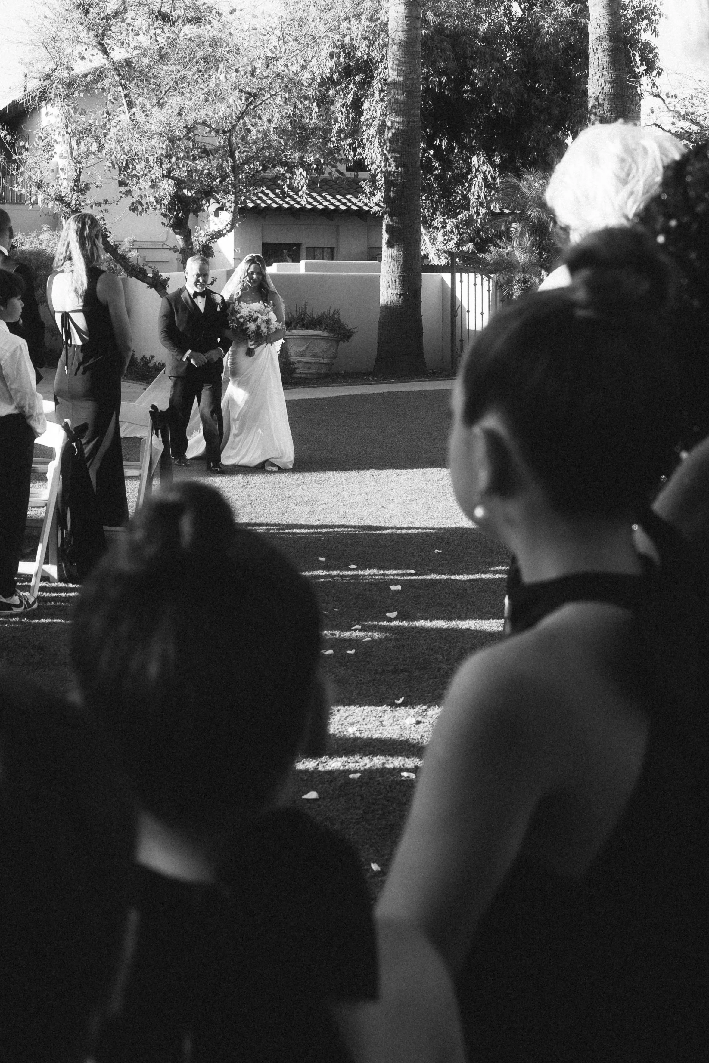 Documentary wedding photograph of a bride and her dad entering the wedding ceremony at a southern California wedding 