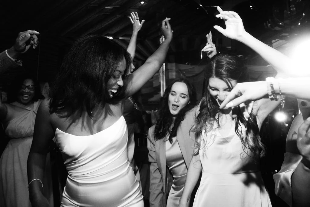 Documentary wedding photograph of a bride dancing with her bridesmaids at a California wedding 