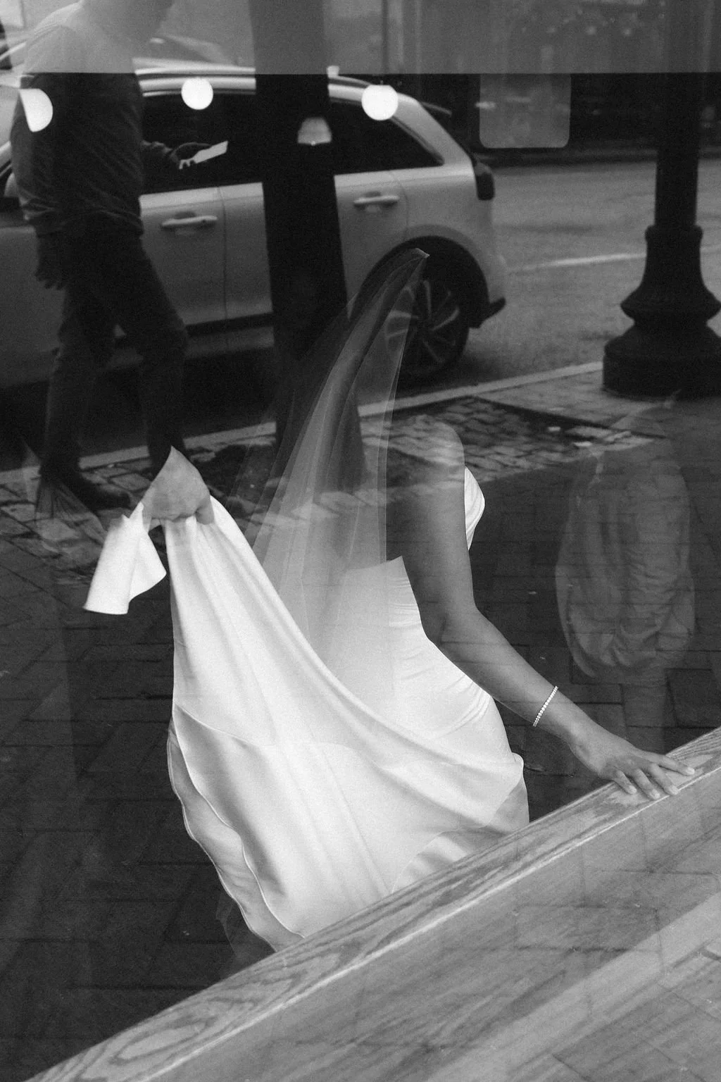 Documentary wedding photo of a bride walking down stairs at a San Diego wedding