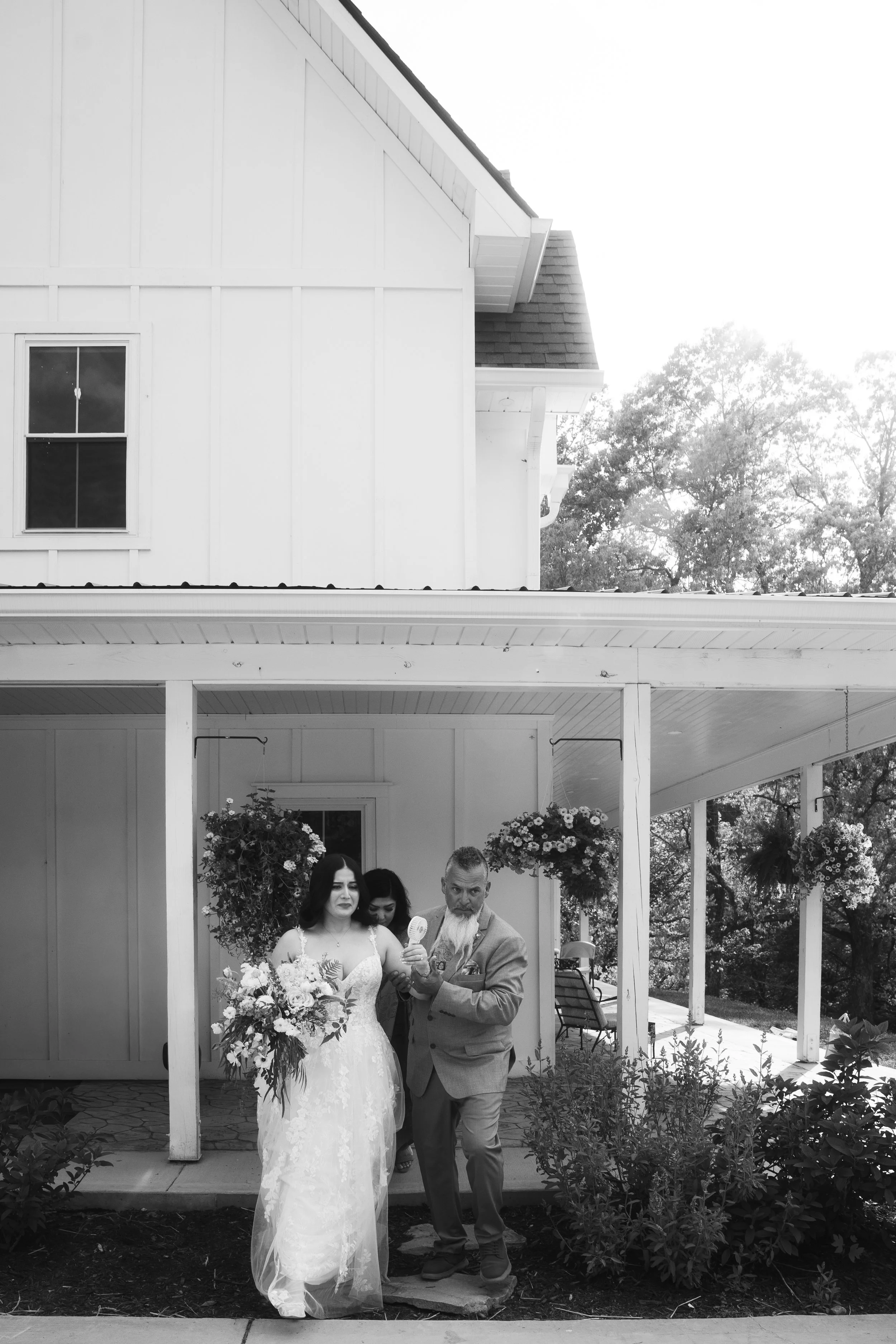Documentary wedding photograph of a bride and her father as they leave the getting ready location to enter the wedding ceremony in southern California