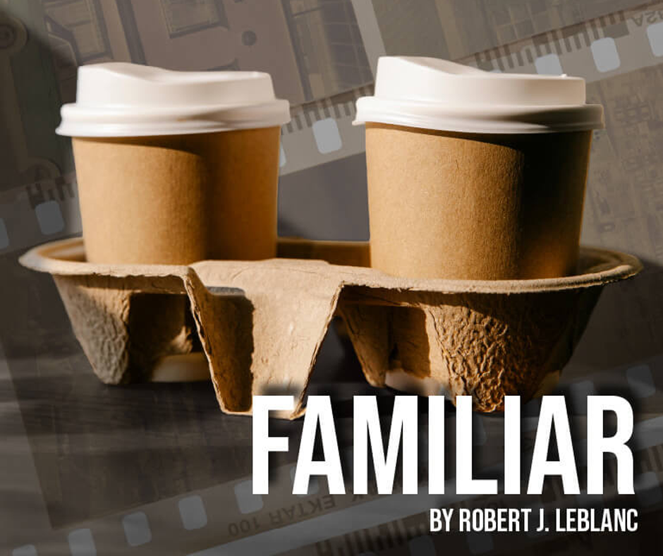Two disposable coffee cups with white lids in an eco-friendly cardboard carrier.