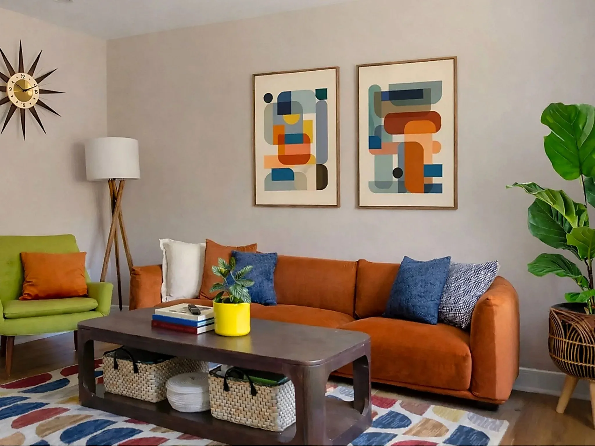 Colorful media room featuring a rust velvet sofa, abstract wall art, patterned rug, and modern wood coffee table in a Montclair, NJ home.