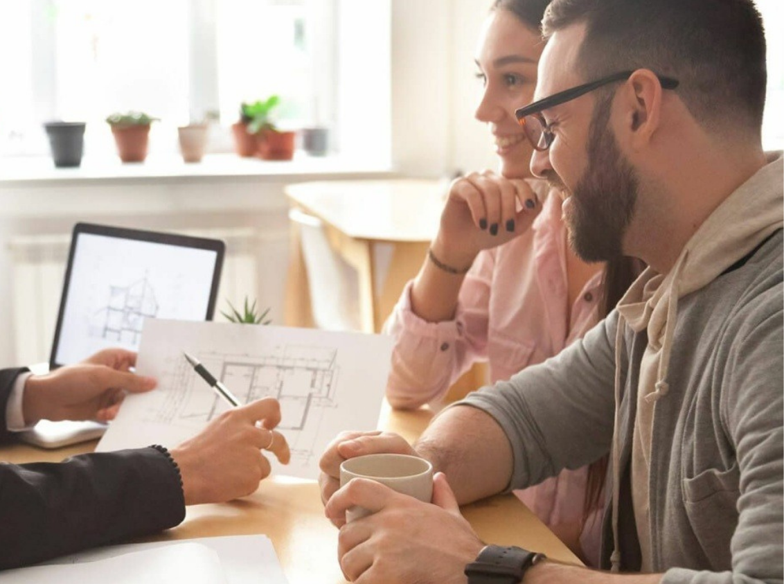 Interior designer meeting with homeowners during a renovation to review plans and manage the full-service design process.