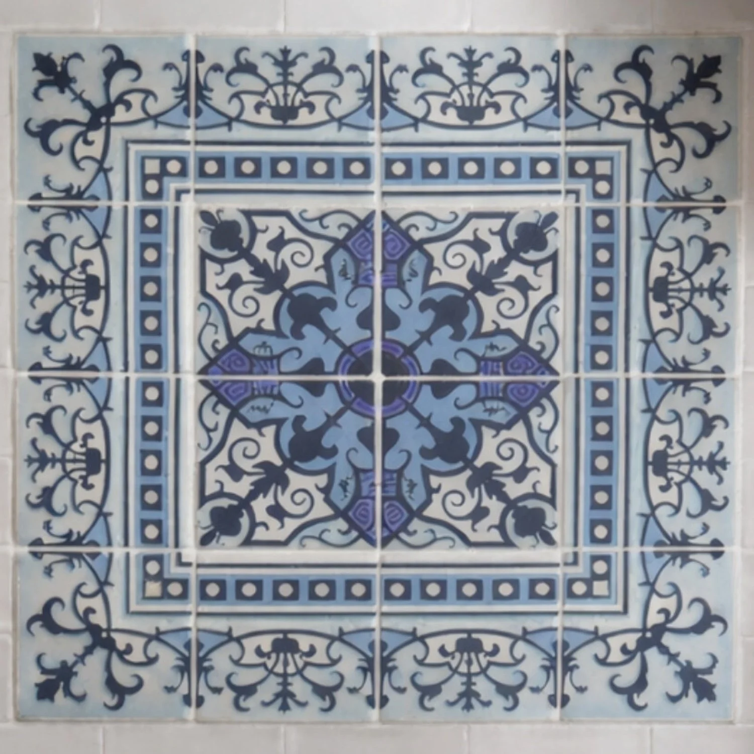 Close-up of blue and white patterned backsplash tile in a bright kitchen designed by Caroline by Design in Bloomfield, New Jersey.